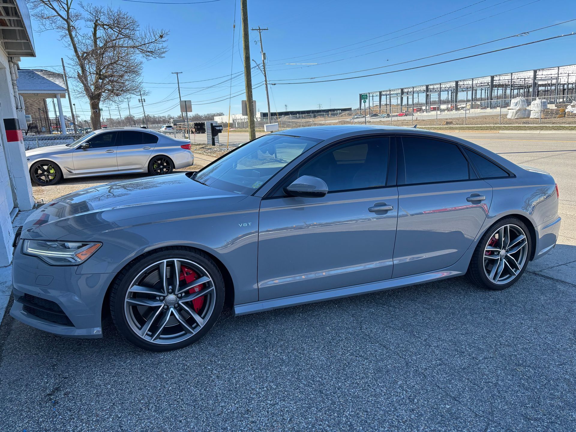 A gray audi a6 is parked in a parking lot.