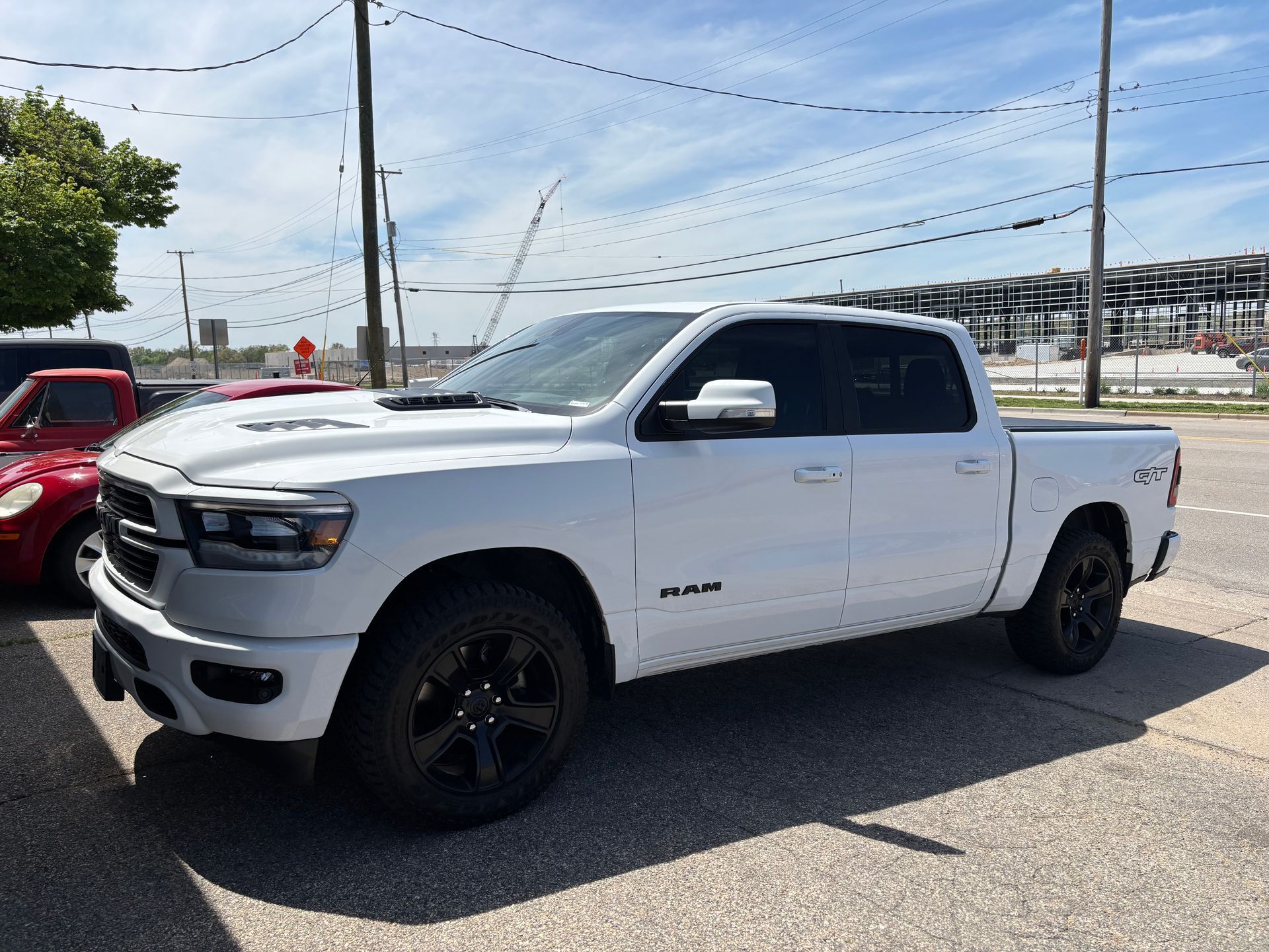 A white ram 1500 truck is parked in a parking lot.