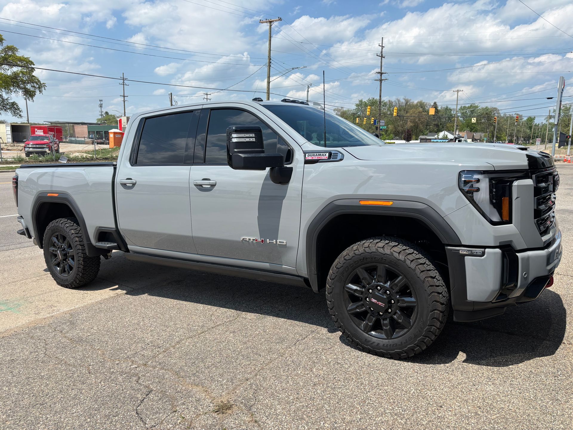 A gray pickup truck is parked in a parking lot.