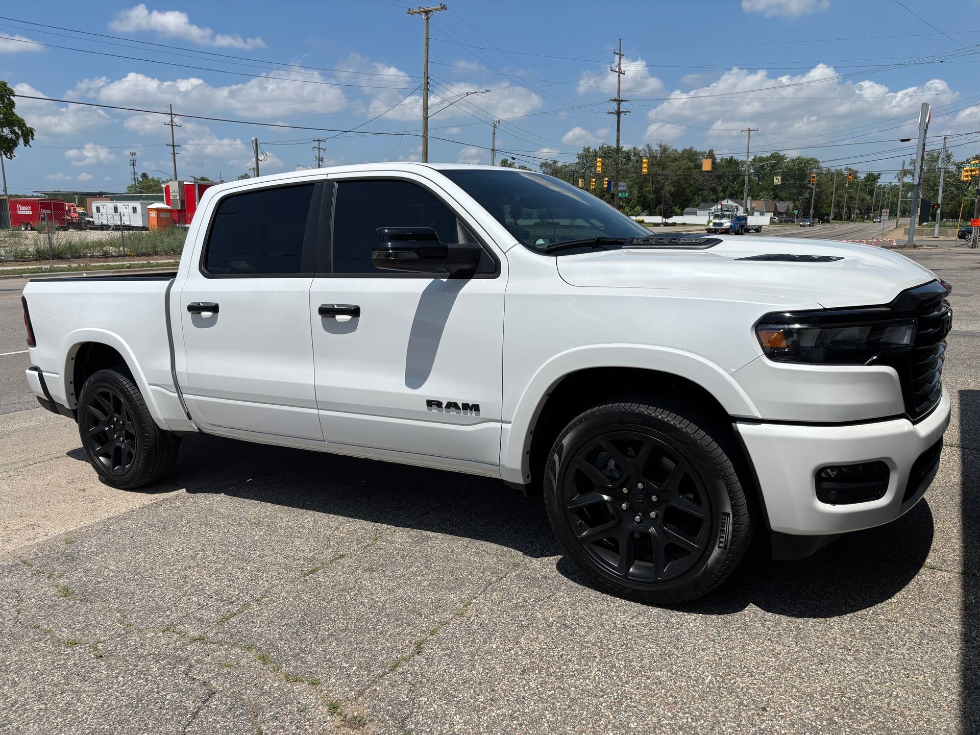 A white ram truck is parked in a parking lot.