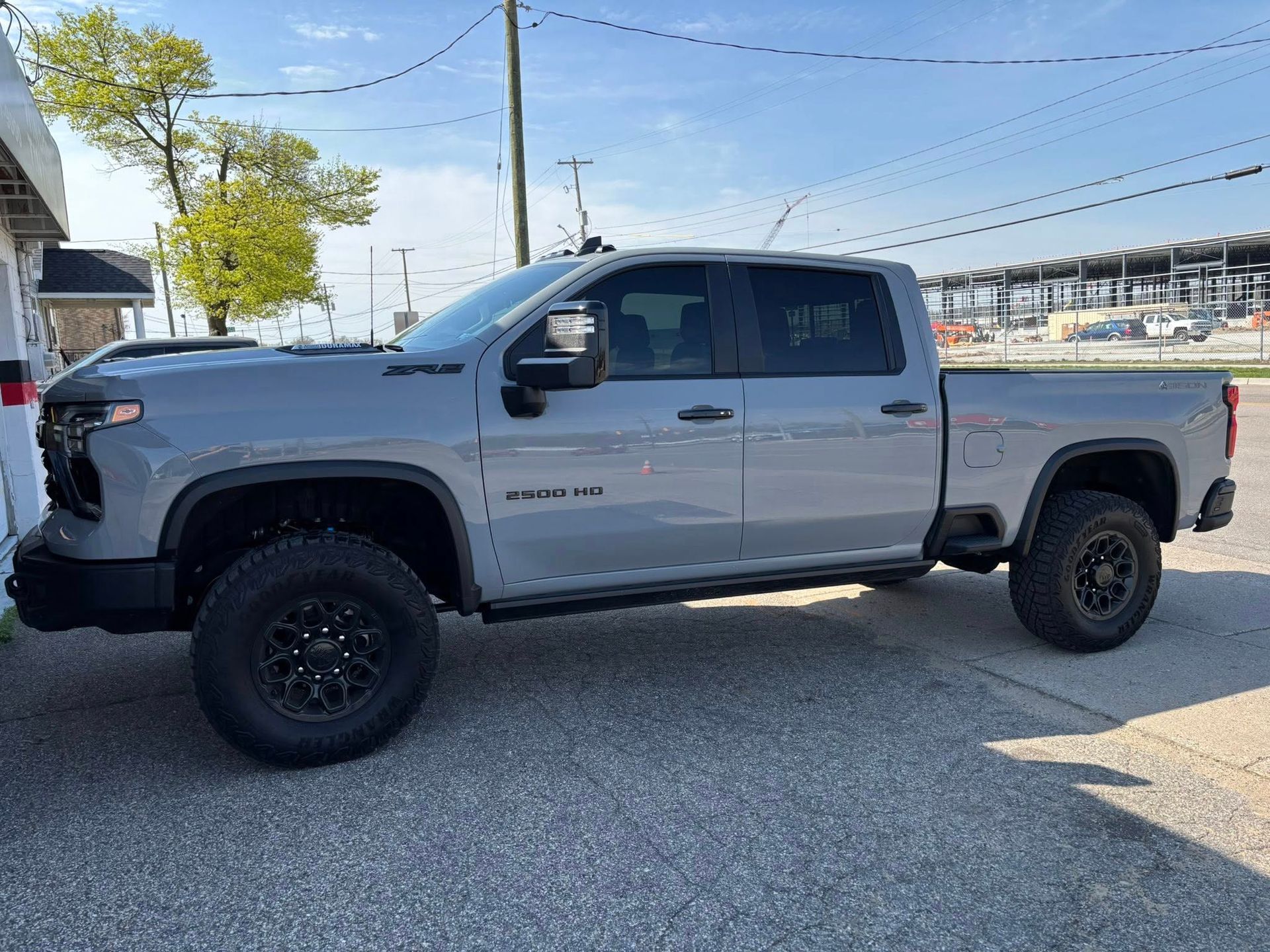 A gray pickup truck is parked on the side of the road.