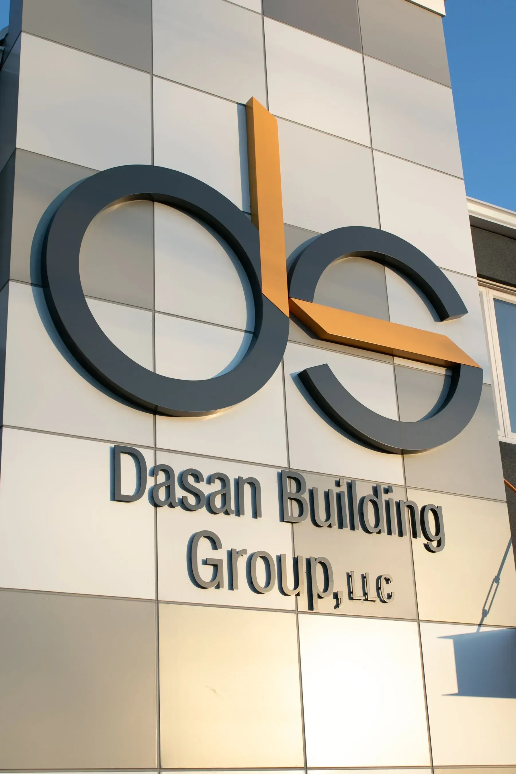 Dasan Building Group, LLC sign on a building; the letters 