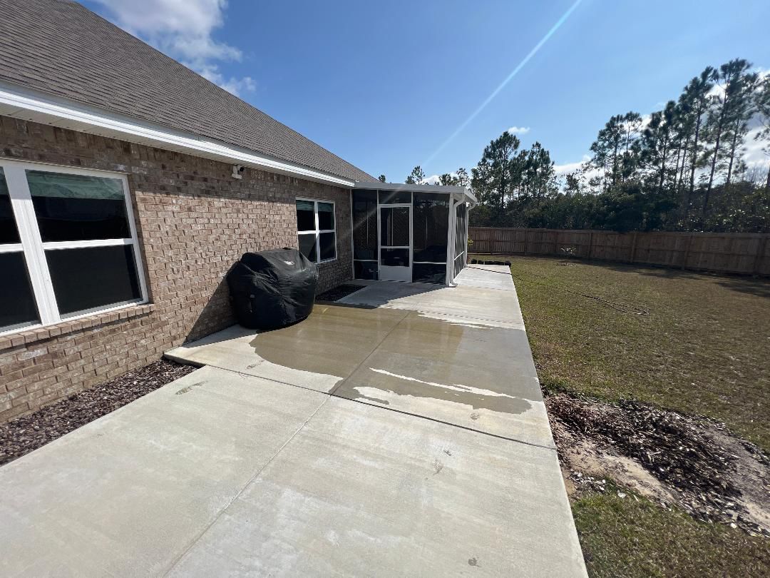 A brick house with a patio in front of it.