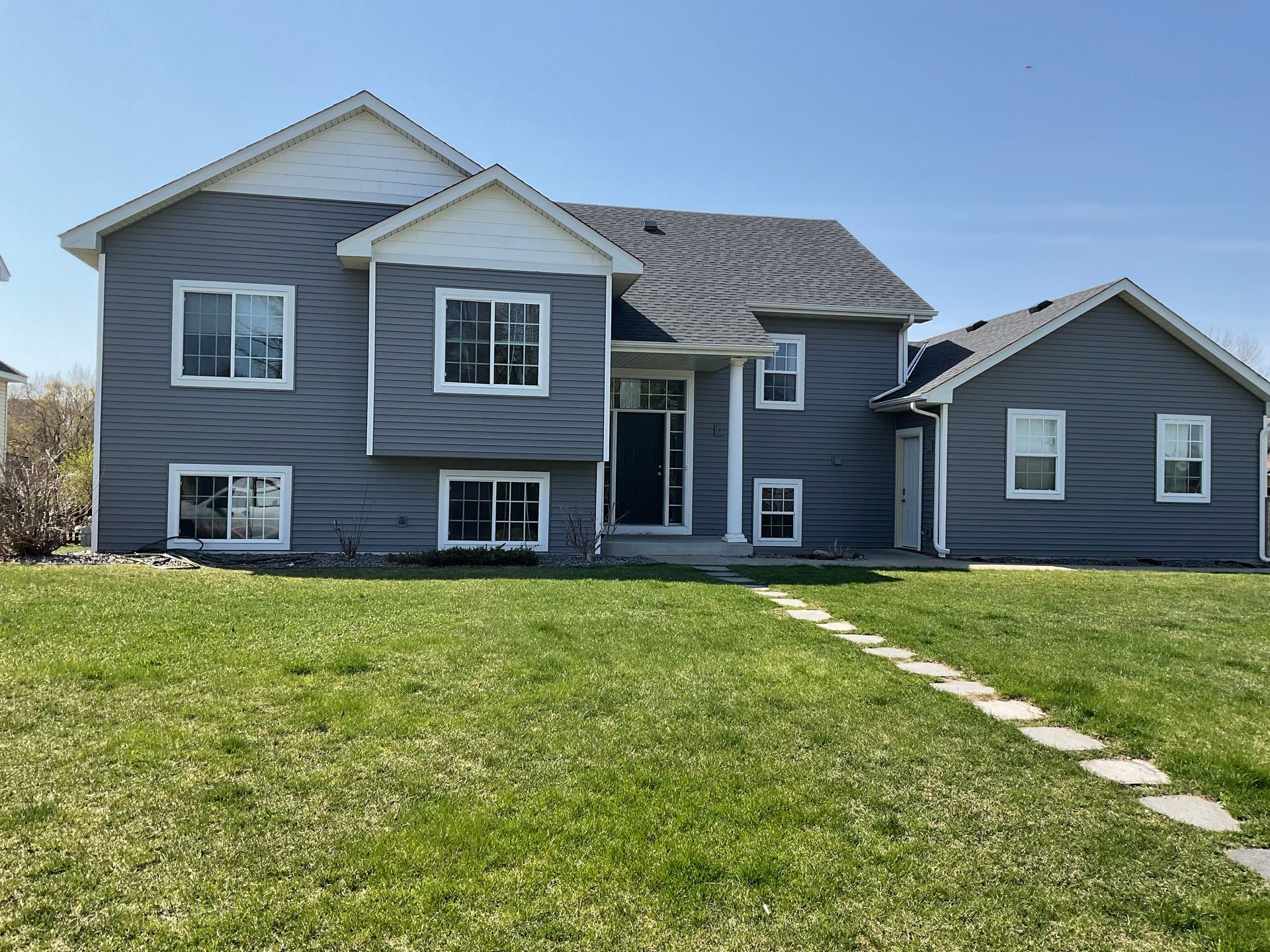 A large house with a lush green lawn in front of it