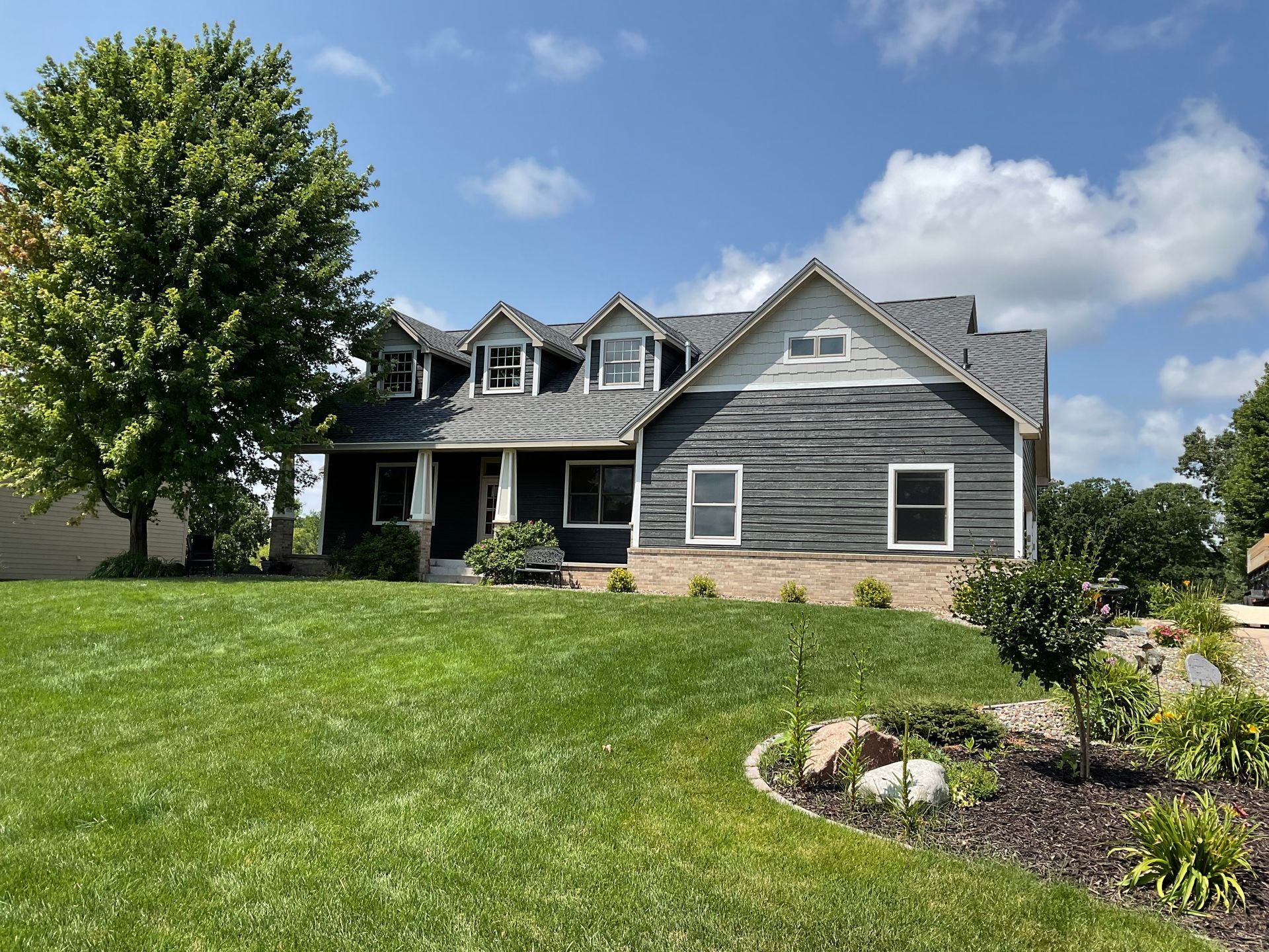 A large house with a large lawn in front of it.