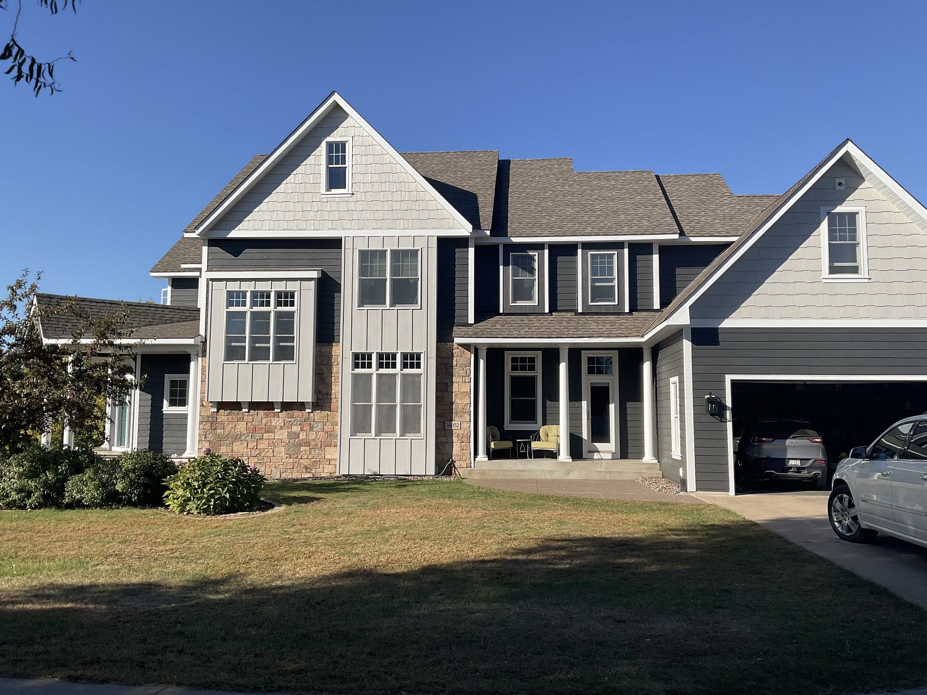 A large house with a car parked in front of it.