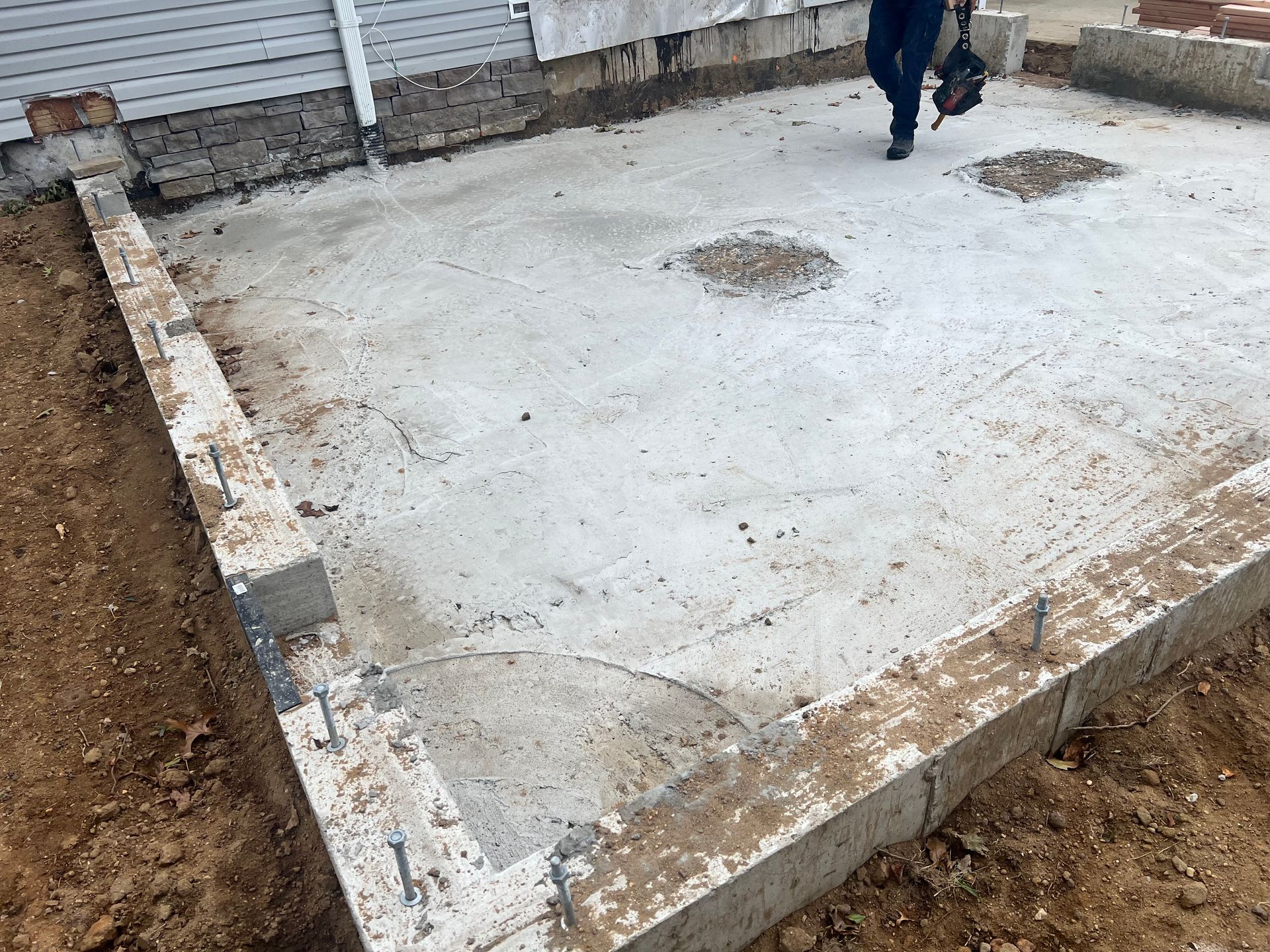 Concrete slab foundation with a person walking.
