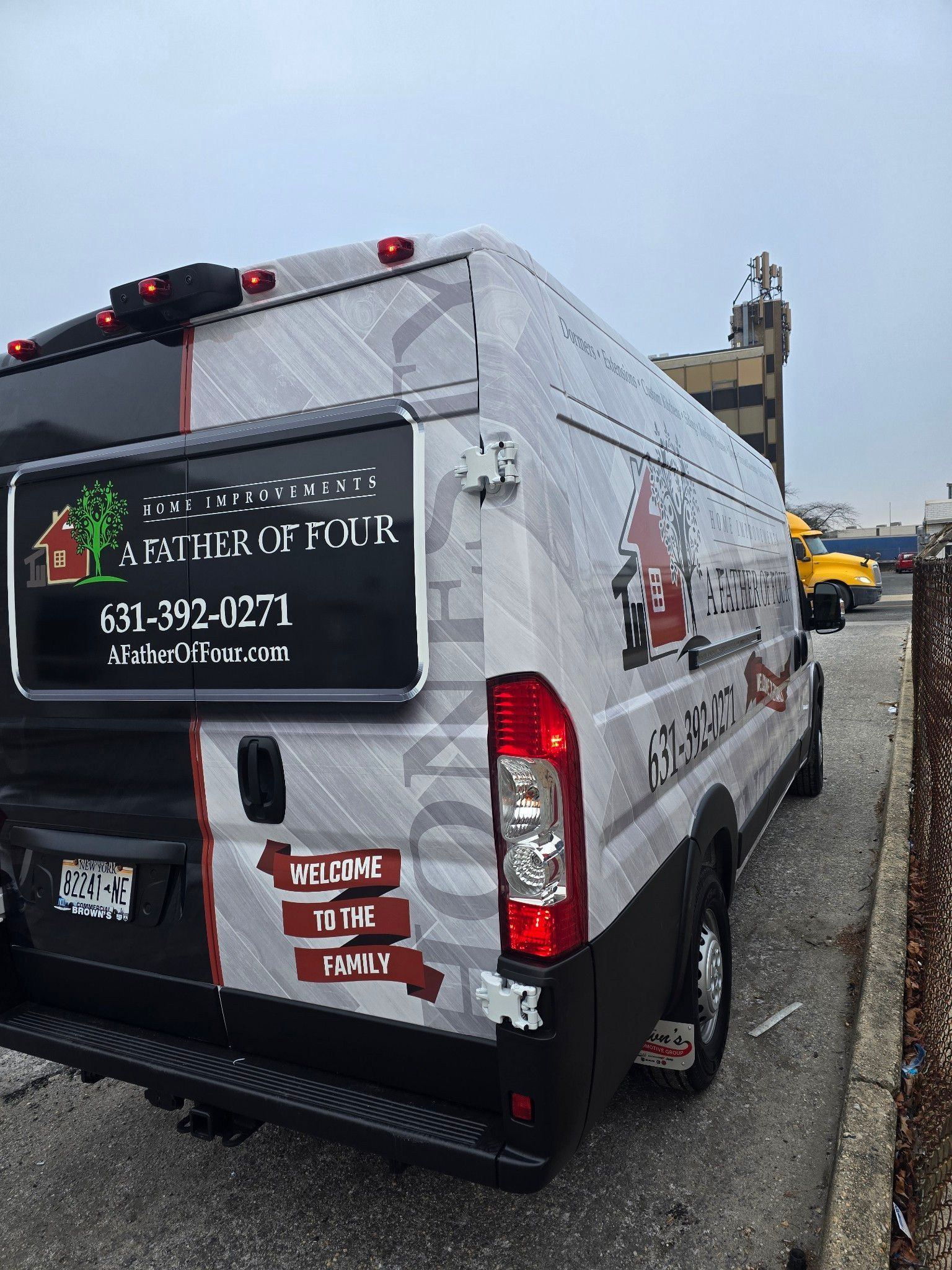 Van with landscaping company branding parked on the side of a road.