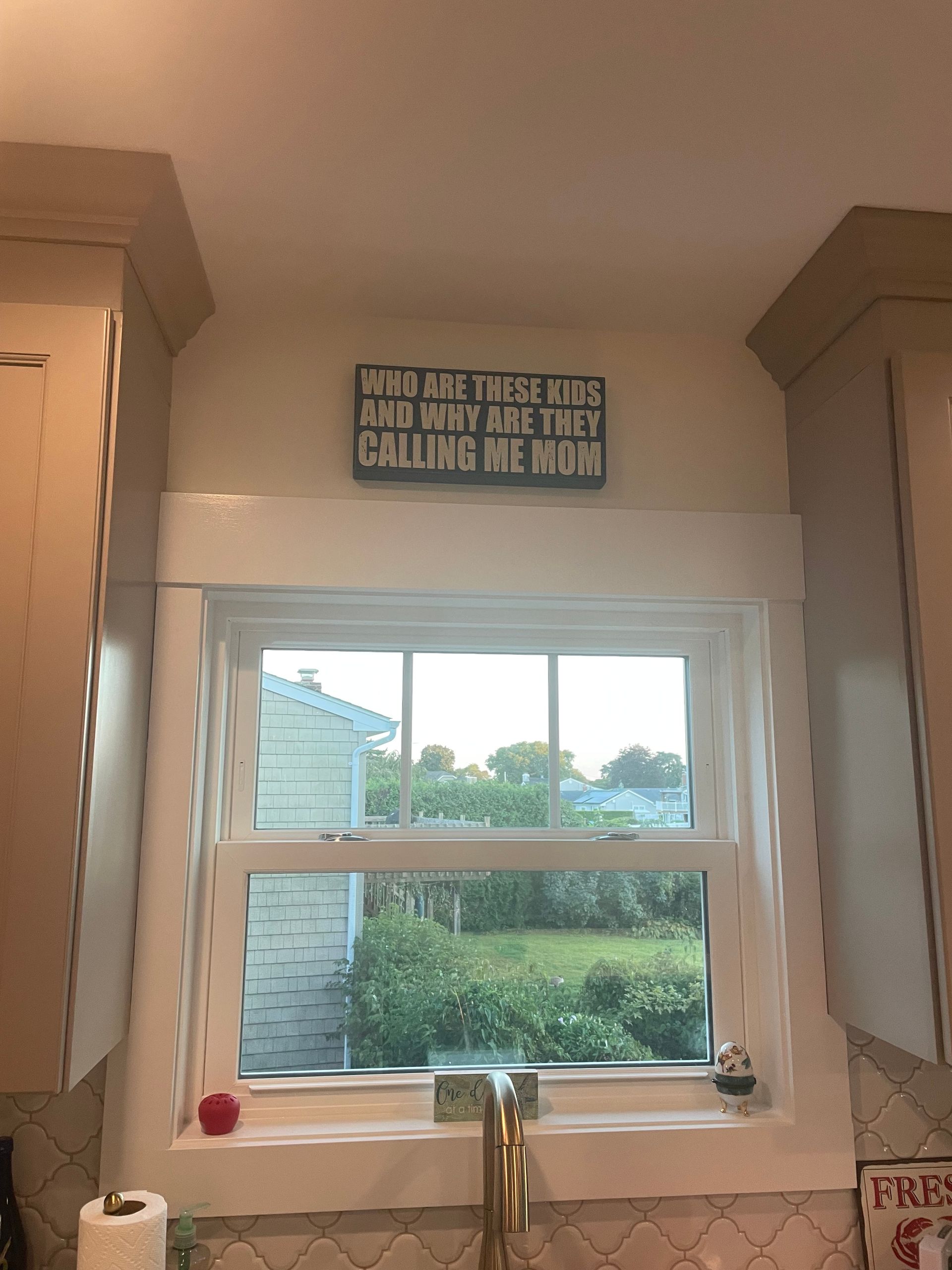 Kitchen with window, sign above reads 