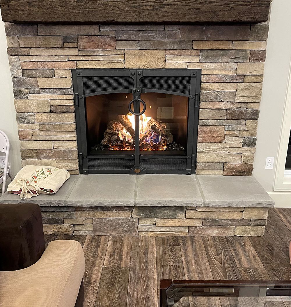 A living room with a fireplace and a chair.