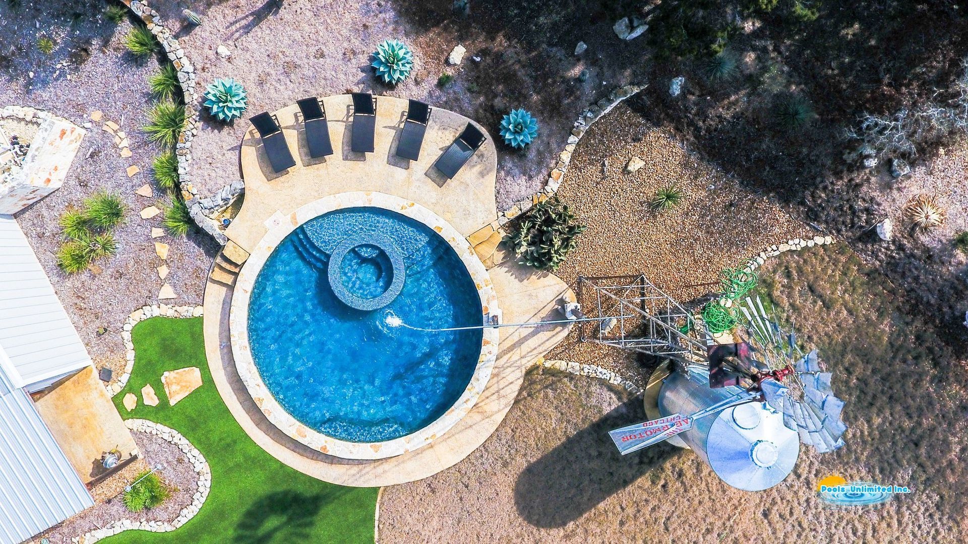 An aerial view of a large swimming pool in a backyard.