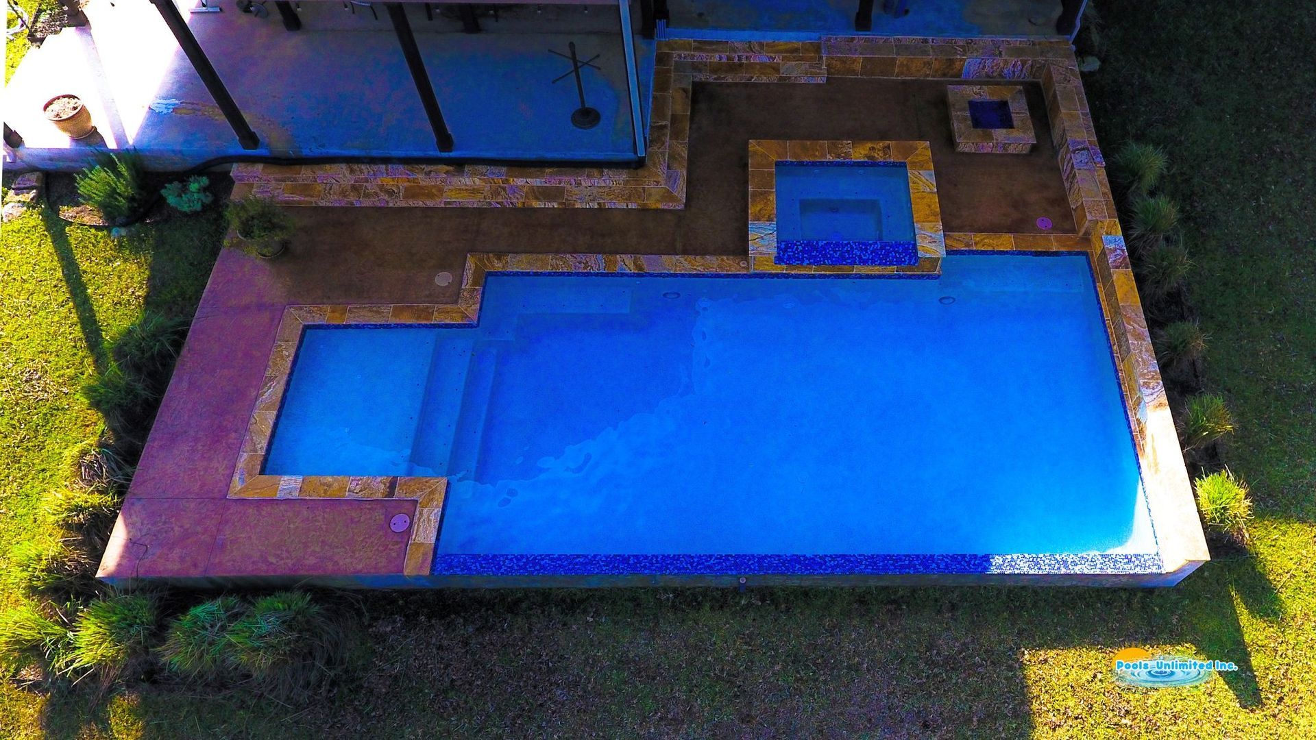 A large house with a swimming pool in front of it