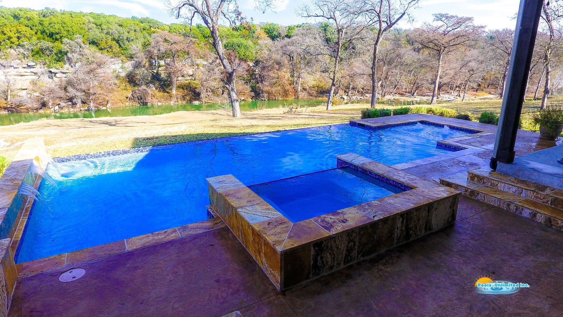 An aerial view of a large swimming pool in a backyard.