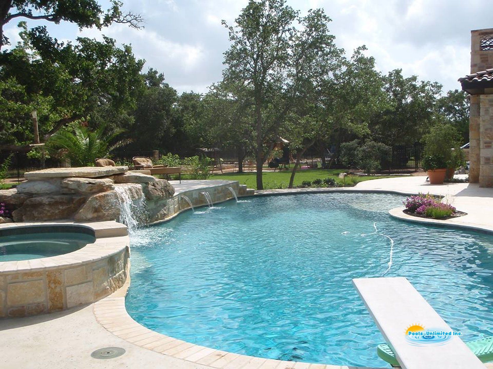 A large swimming pool with a waterfall in the middle of it.