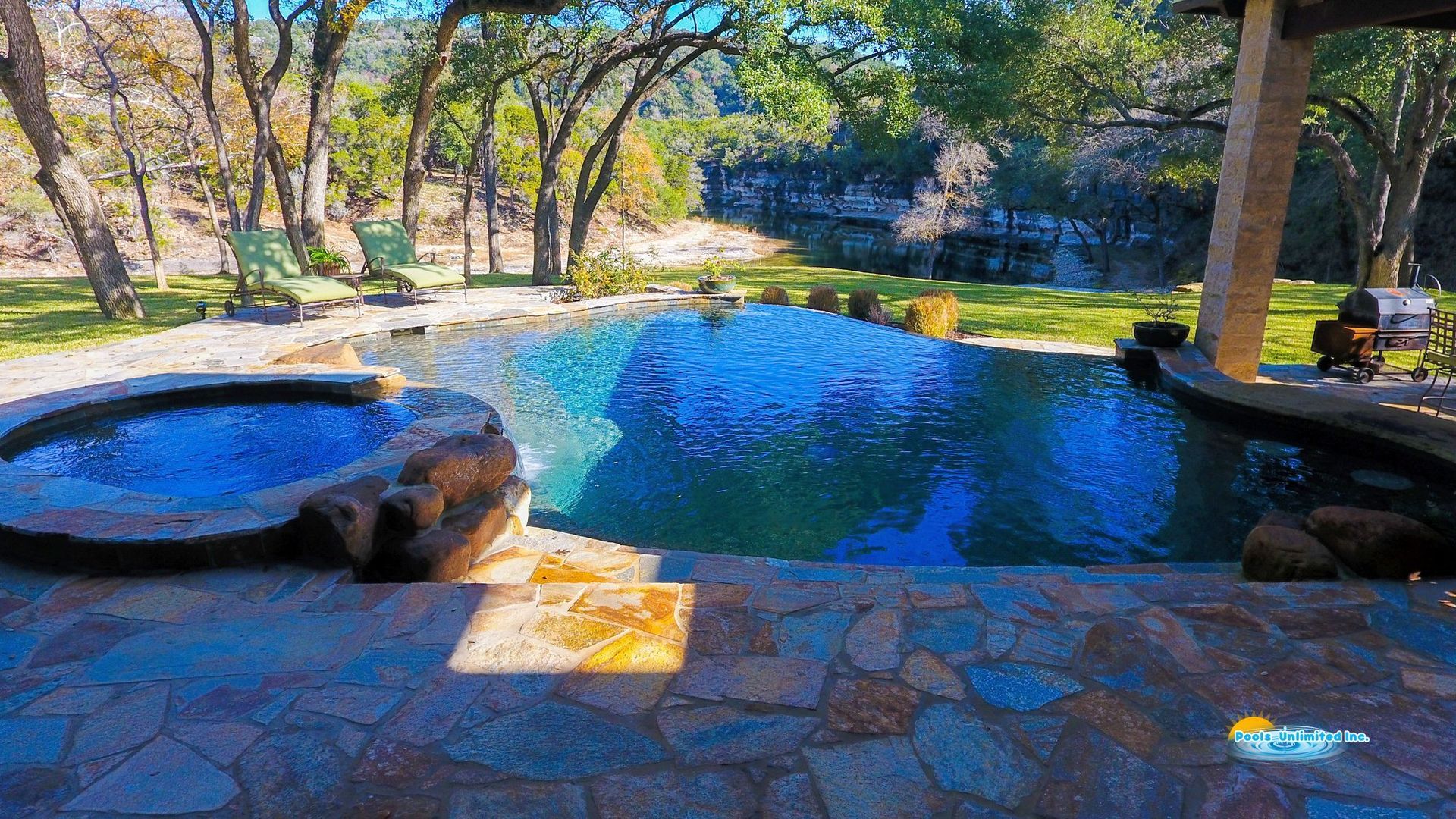 A large swimming pool surrounded by chairs and umbrellas