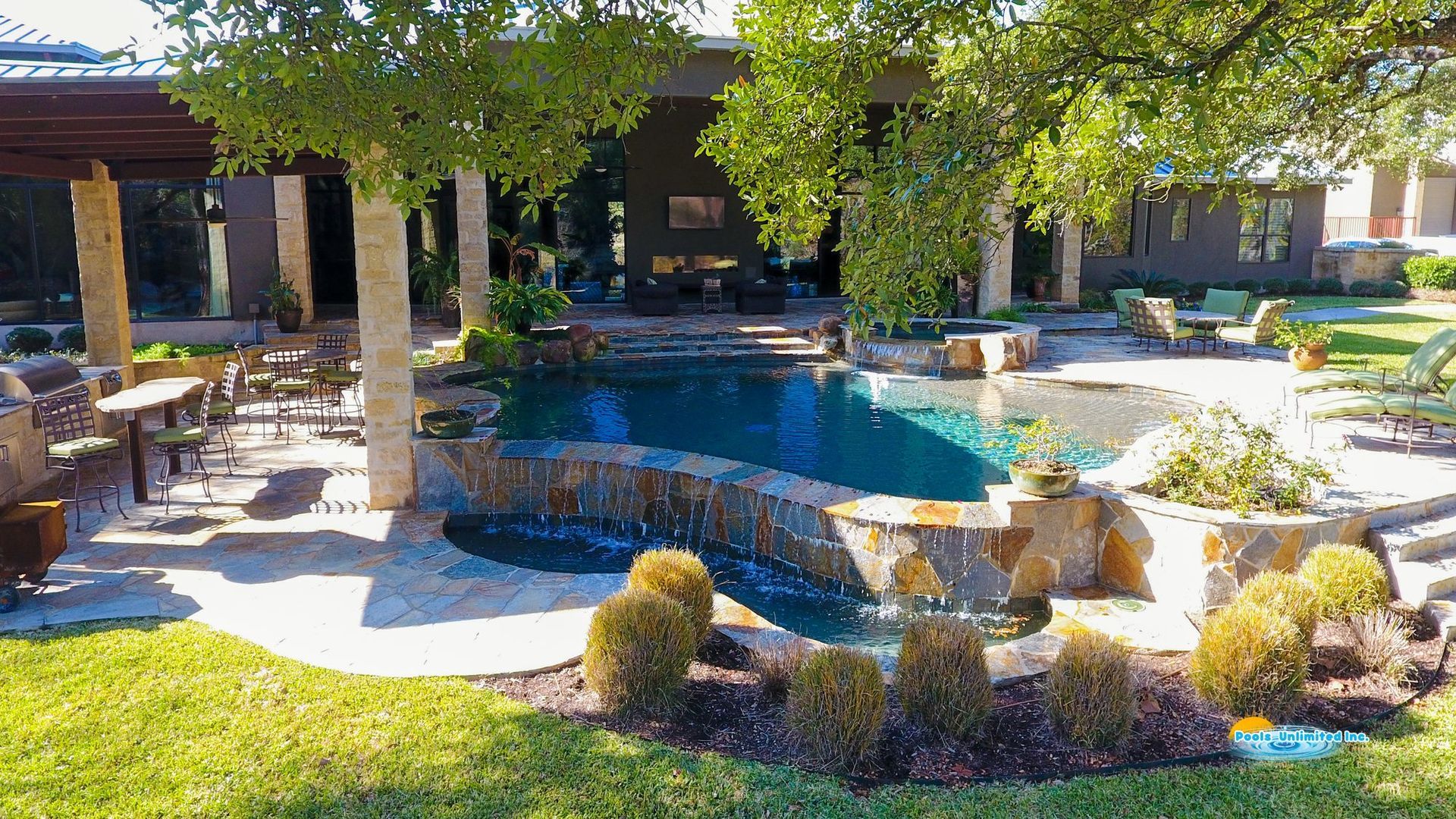 There is a large swimming pool in the backyard of a house.