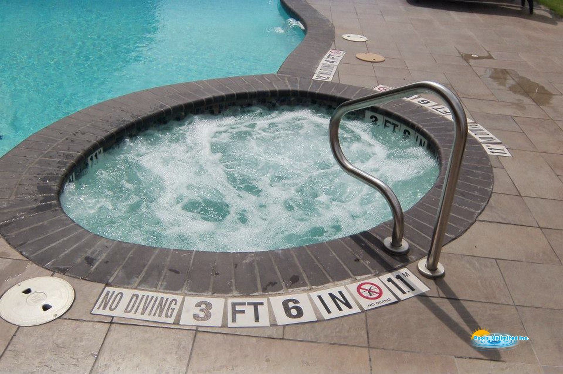 A hot tub is surrounded by a sign that says no diving 3 ft 6 in