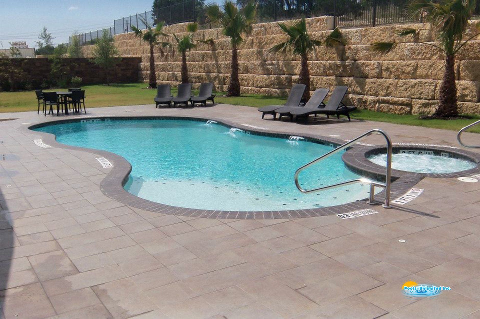 A large swimming pool surrounded by chairs and tables