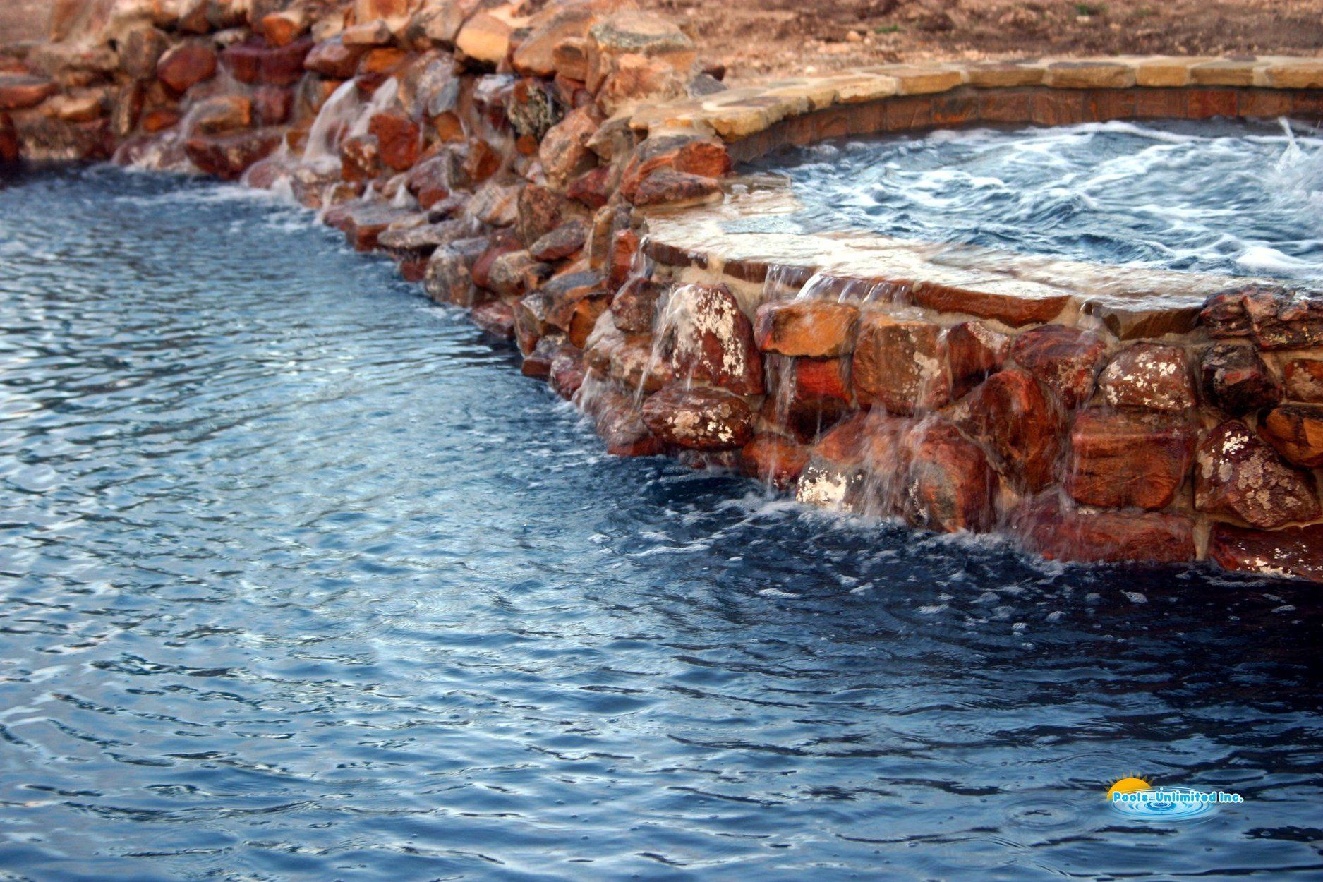 A large body of water is surrounded by a stone wall