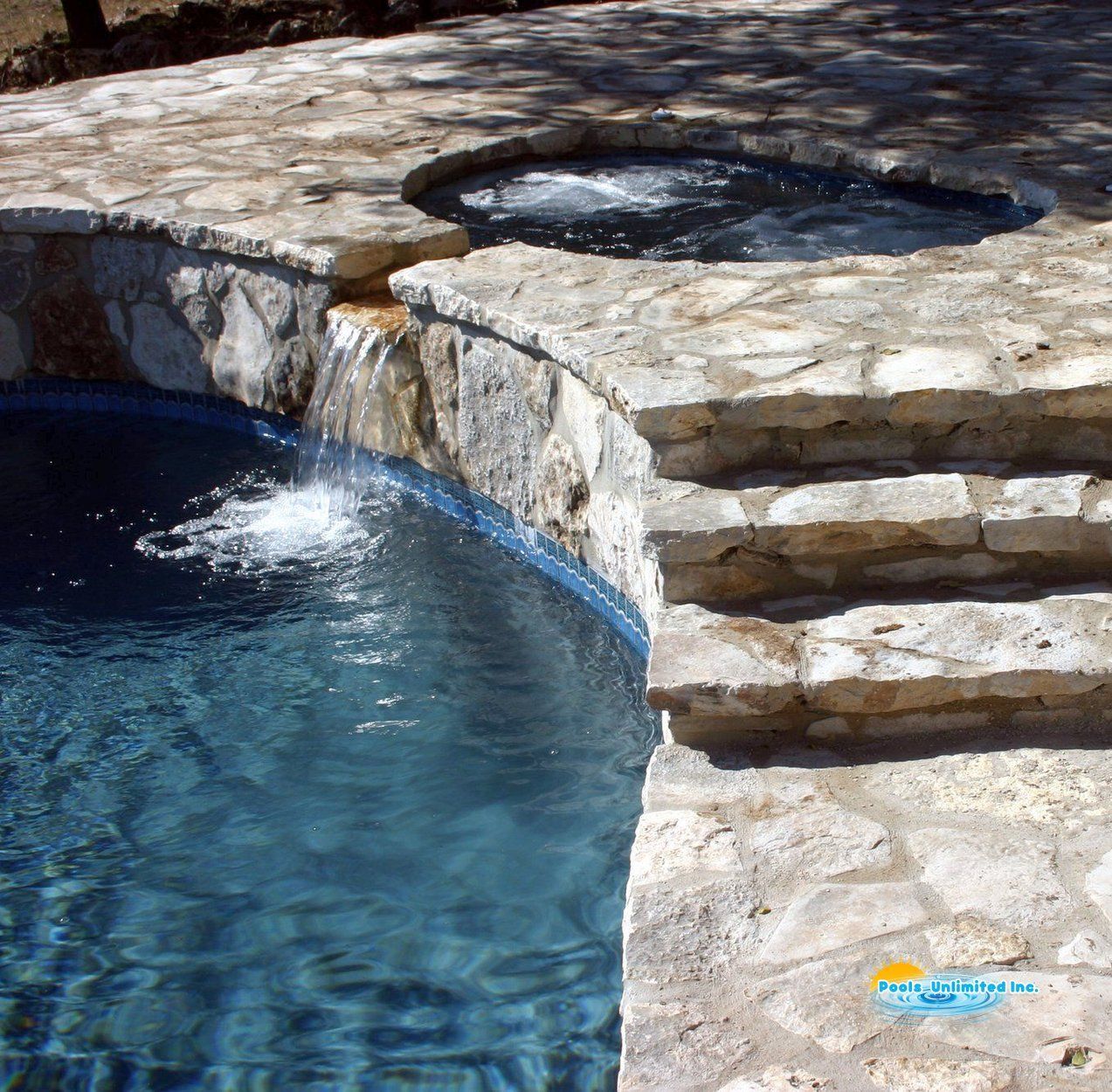 A swimming pool with stairs leading up to it