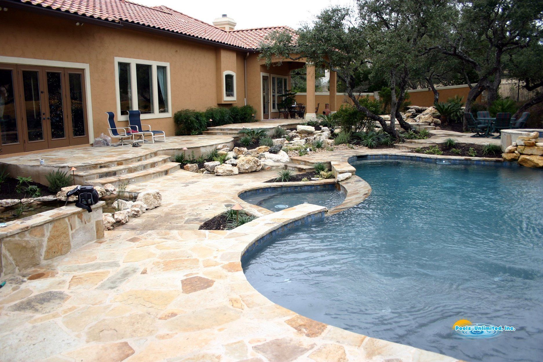 A large house with a large swimming pool in front of it