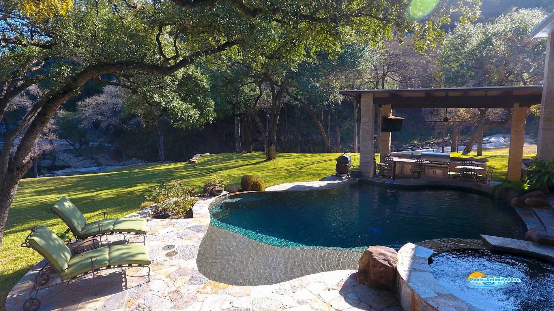 A large swimming pool with a gazebo in the background