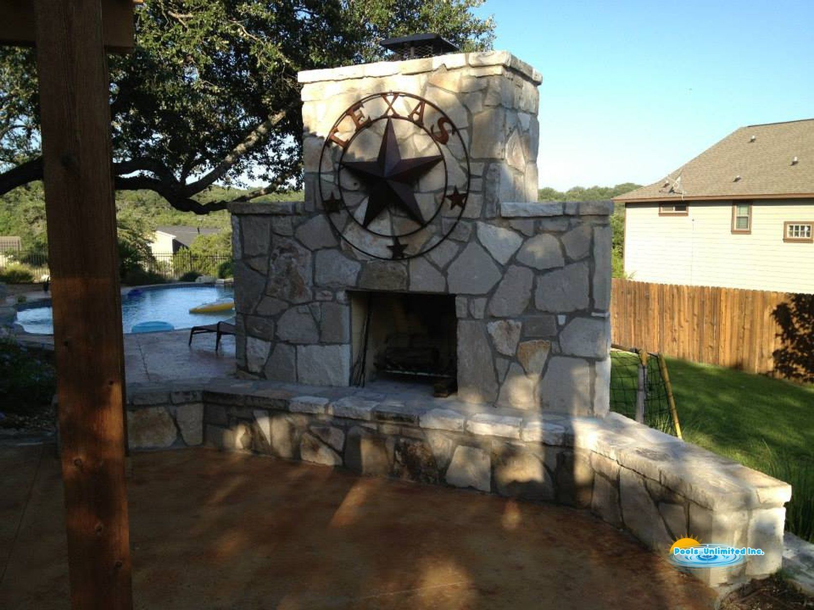 A stone fireplace with a texas star on it