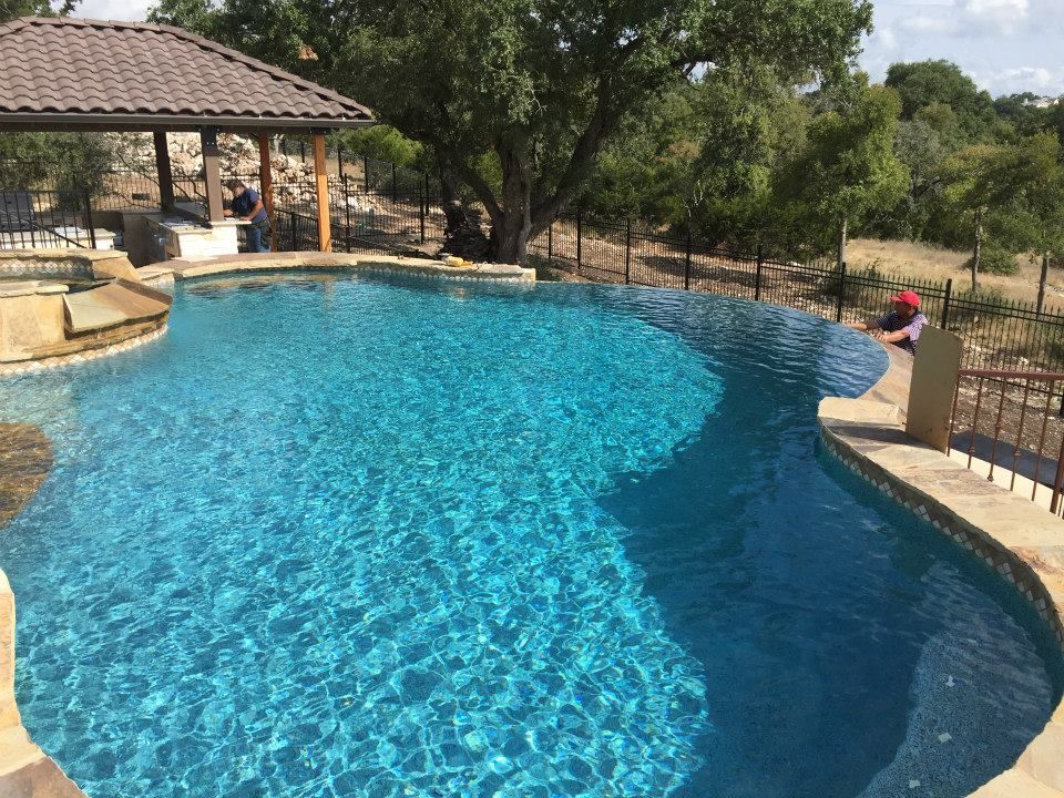 There is a large swimming pool with a gazebo in the background.