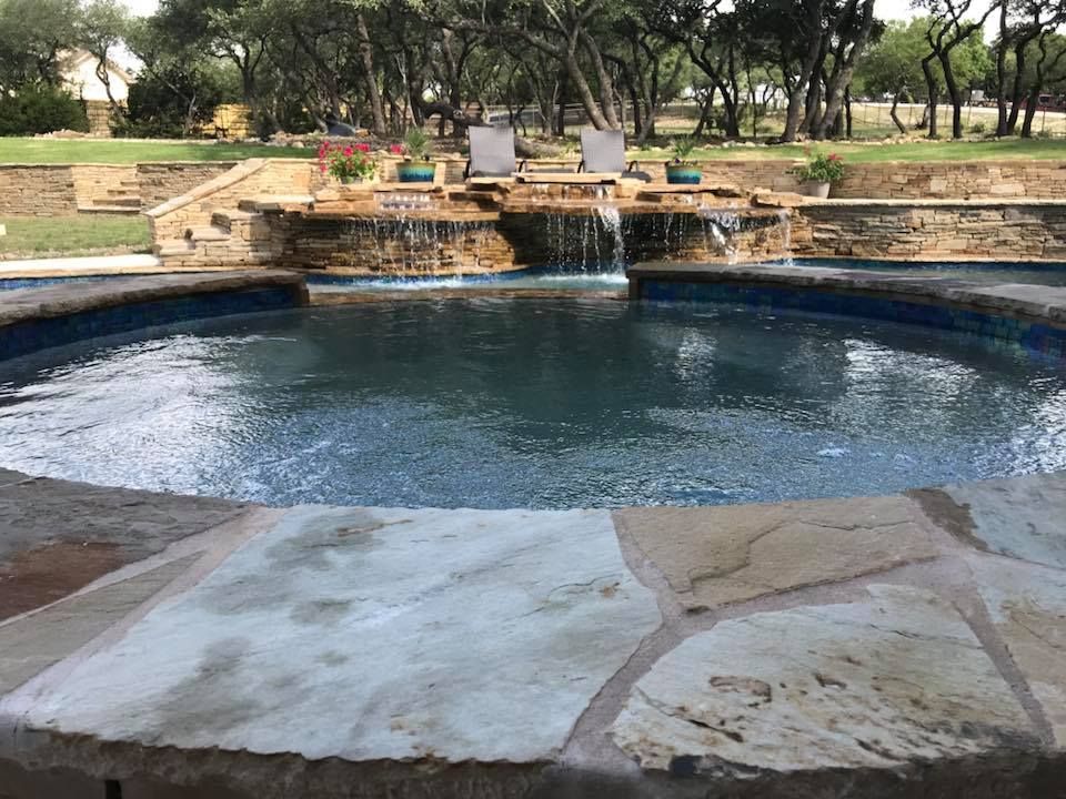 There is a waterfall in the middle of the pool.