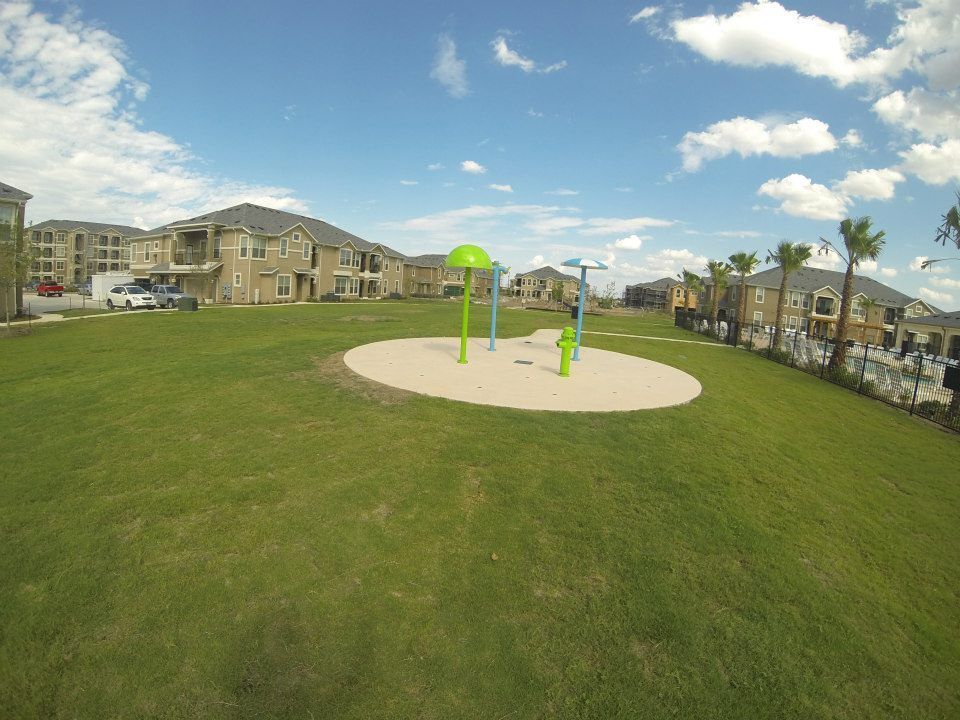 A playground in the middle of a lush green field