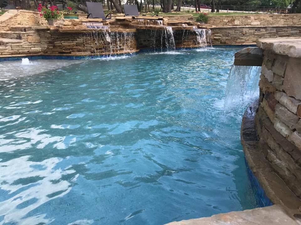 There is a waterfall in the middle of the pool.