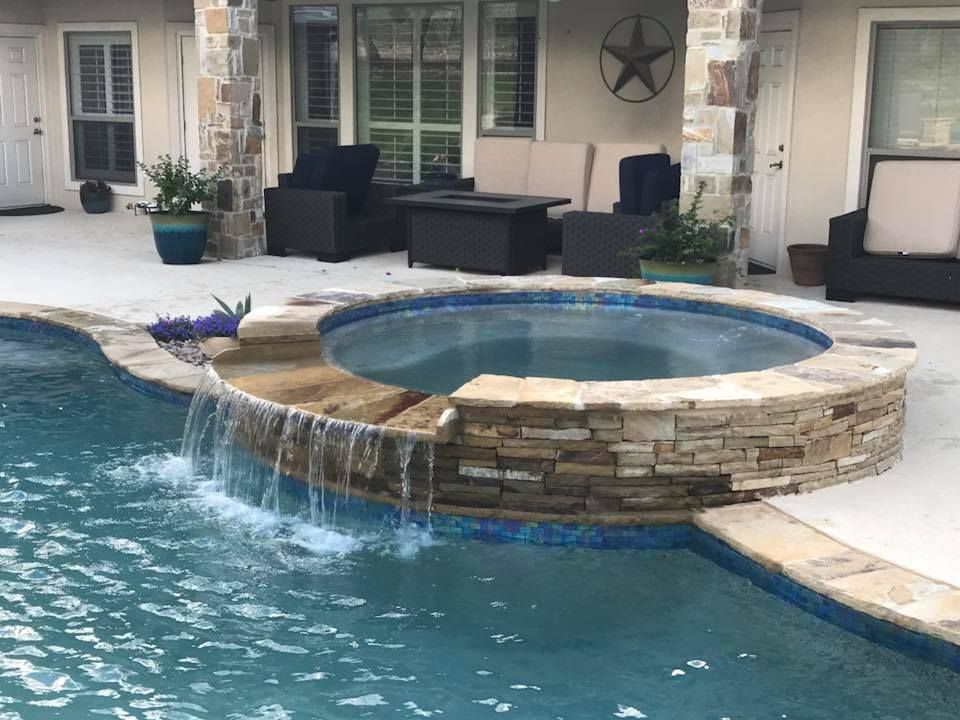 A swimming pool with a waterfall in the middle