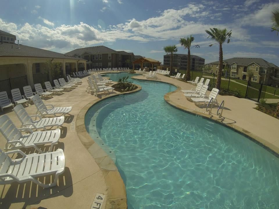 A large swimming pool with a river running through it
