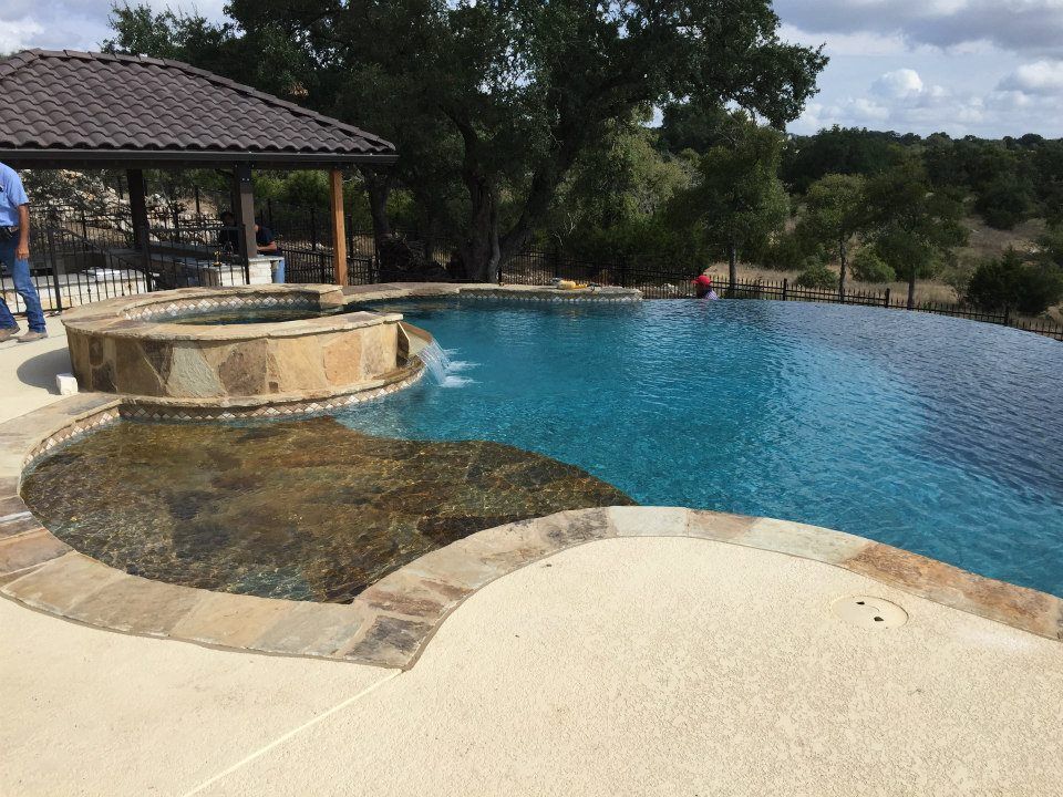 A large swimming pool with a gazebo in the background.