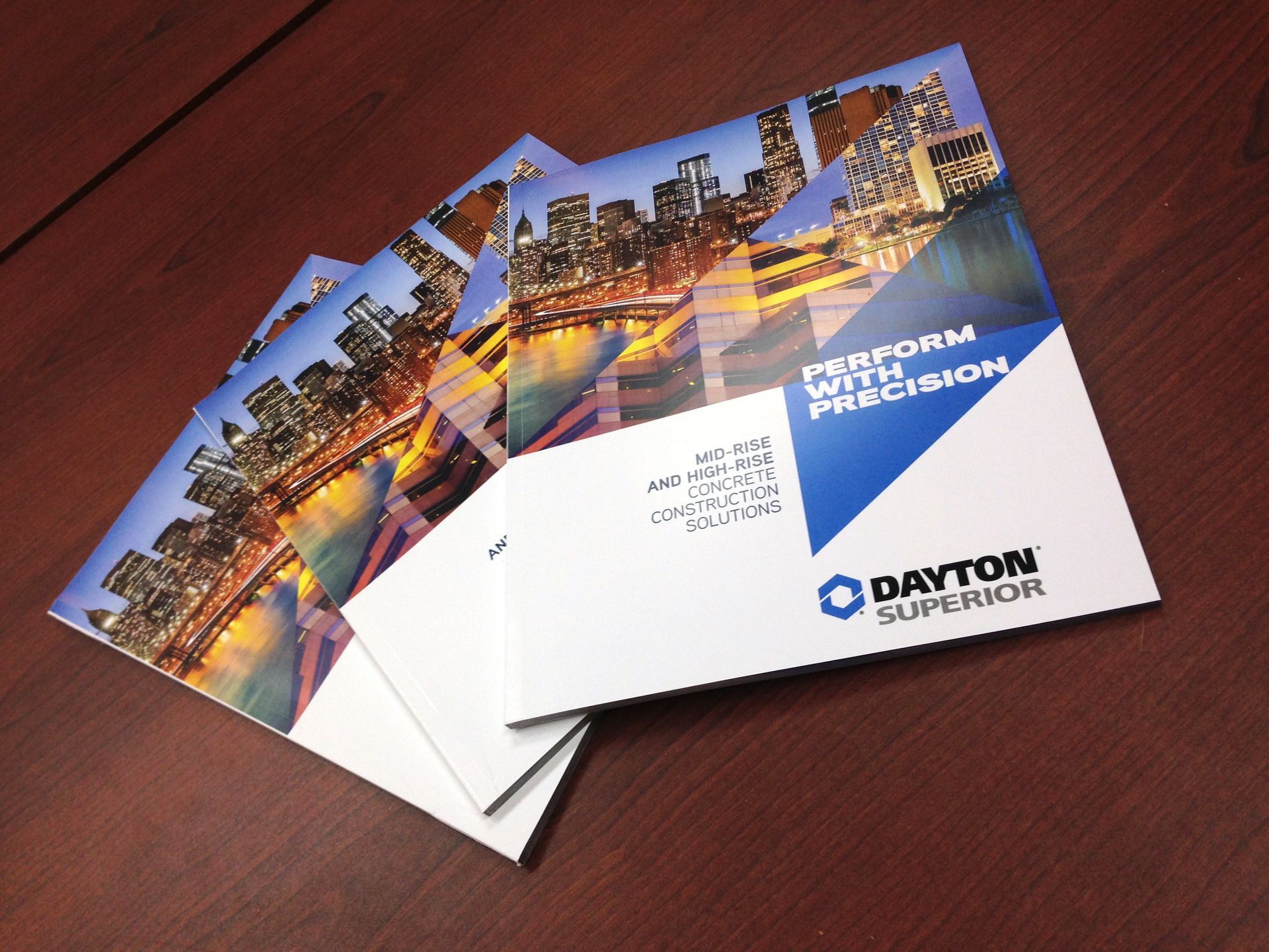 Brochures of Dayton Superior products, showing a cityscape and company logo.