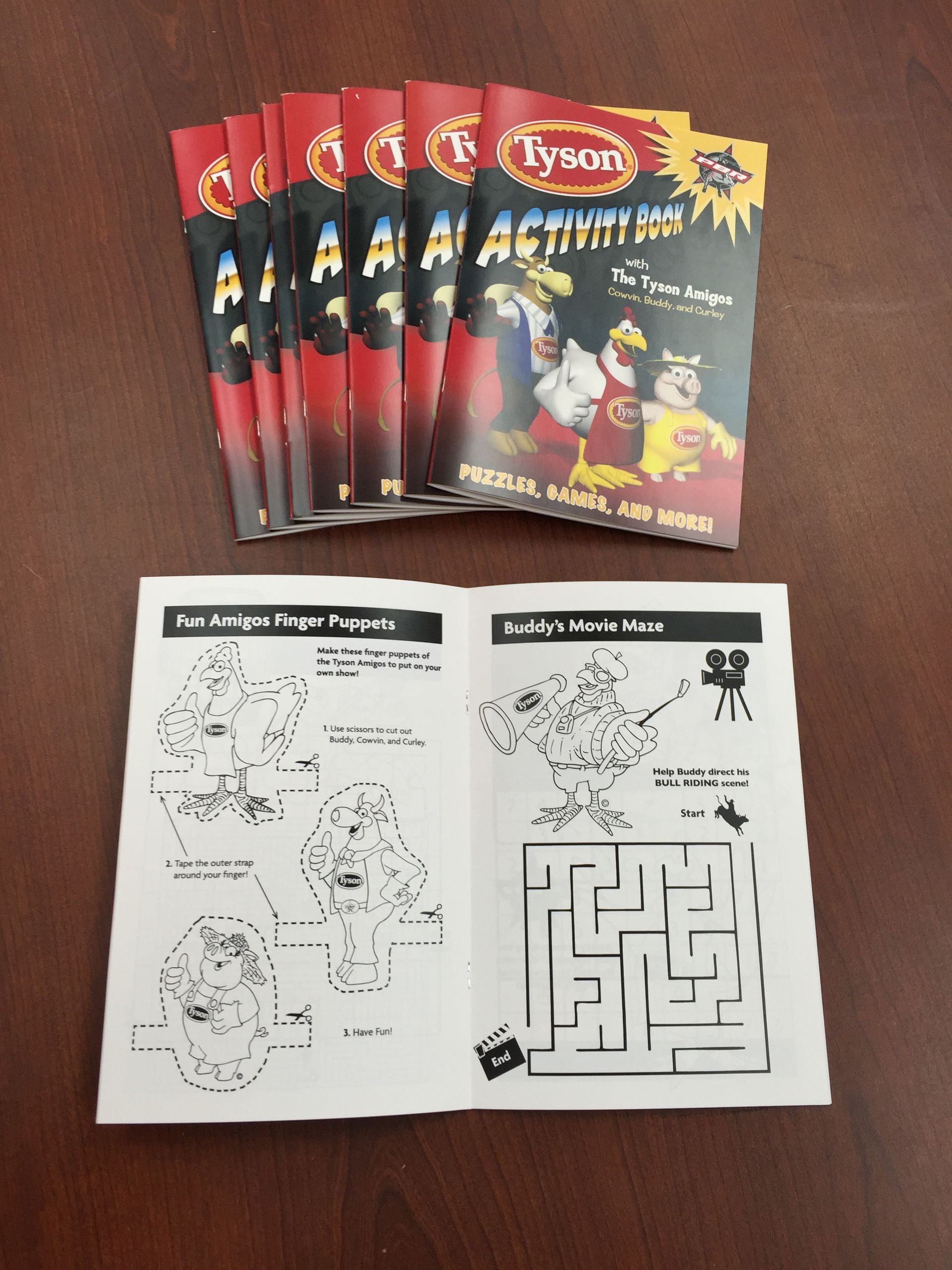 Several Tyson Activity Books and open pages showing coloring pages and a maze.