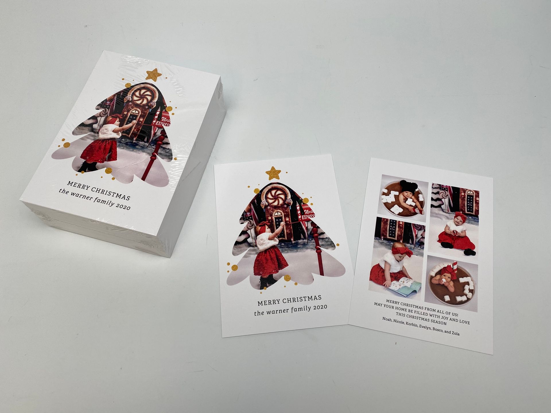 Stack of Christmas cards with a decorative image of a figure in red clothing; two cards displayed.