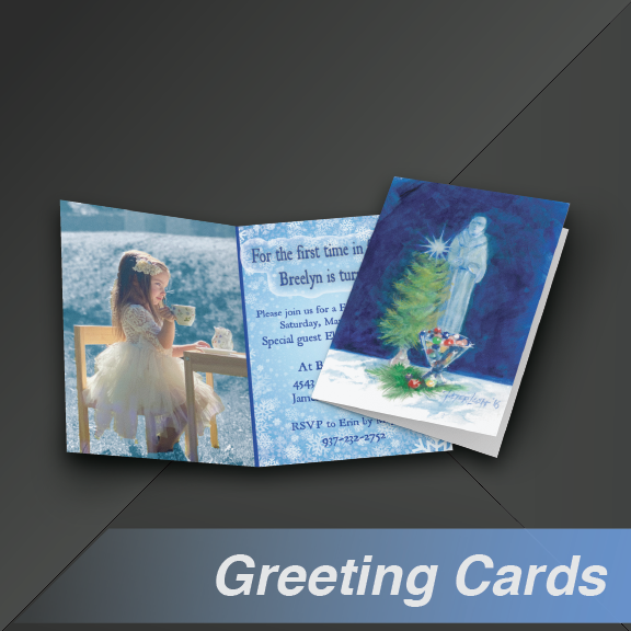 Greeting cards: Open card with child at table and closed card with Christmas art.