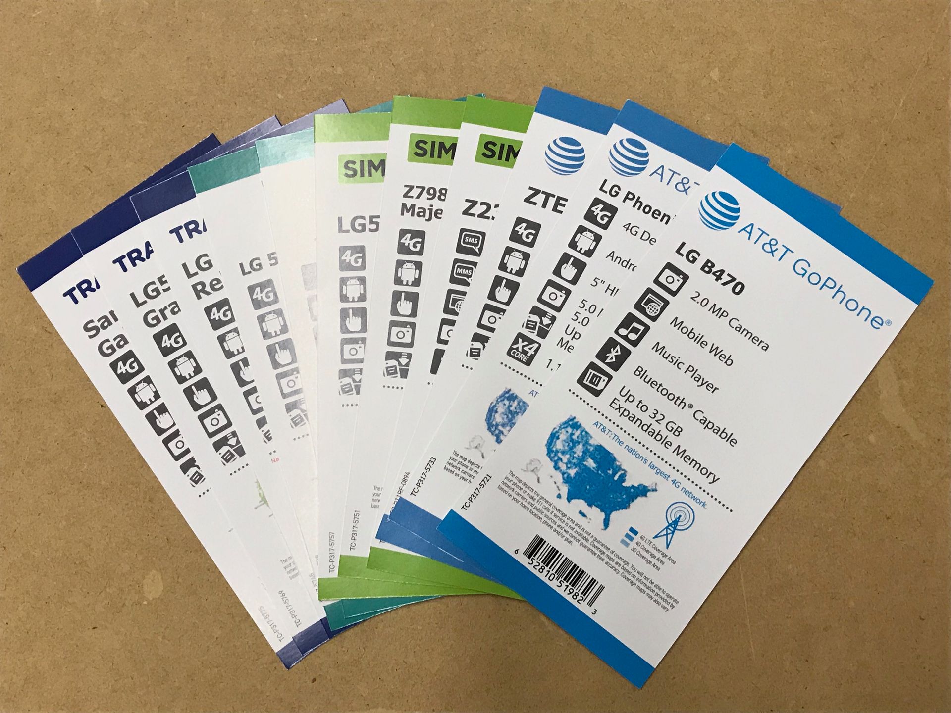 Several SIM card packets with AT&T branding and model information.