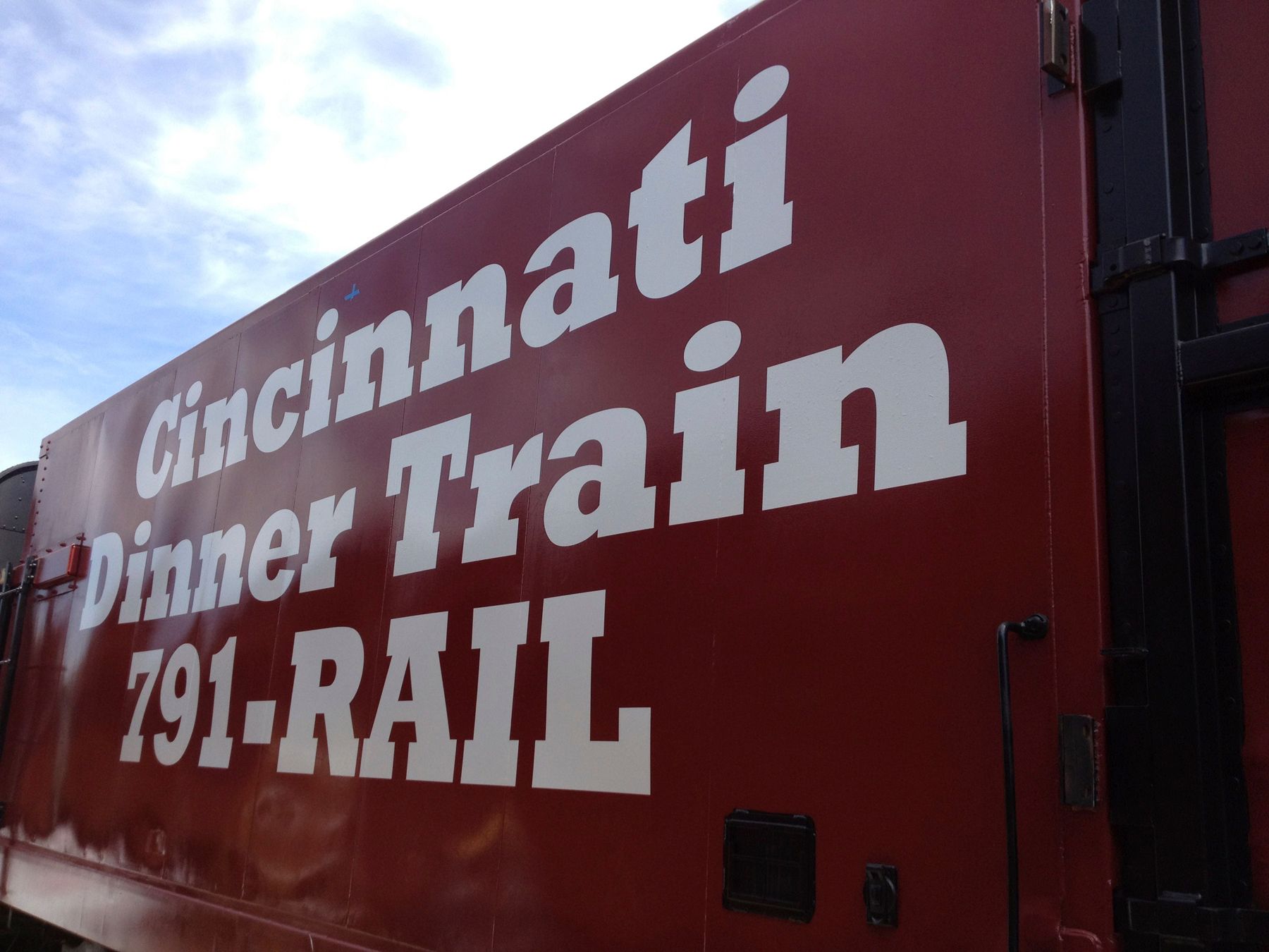 Cincinnati Dinner Train on red train car. White text on red.