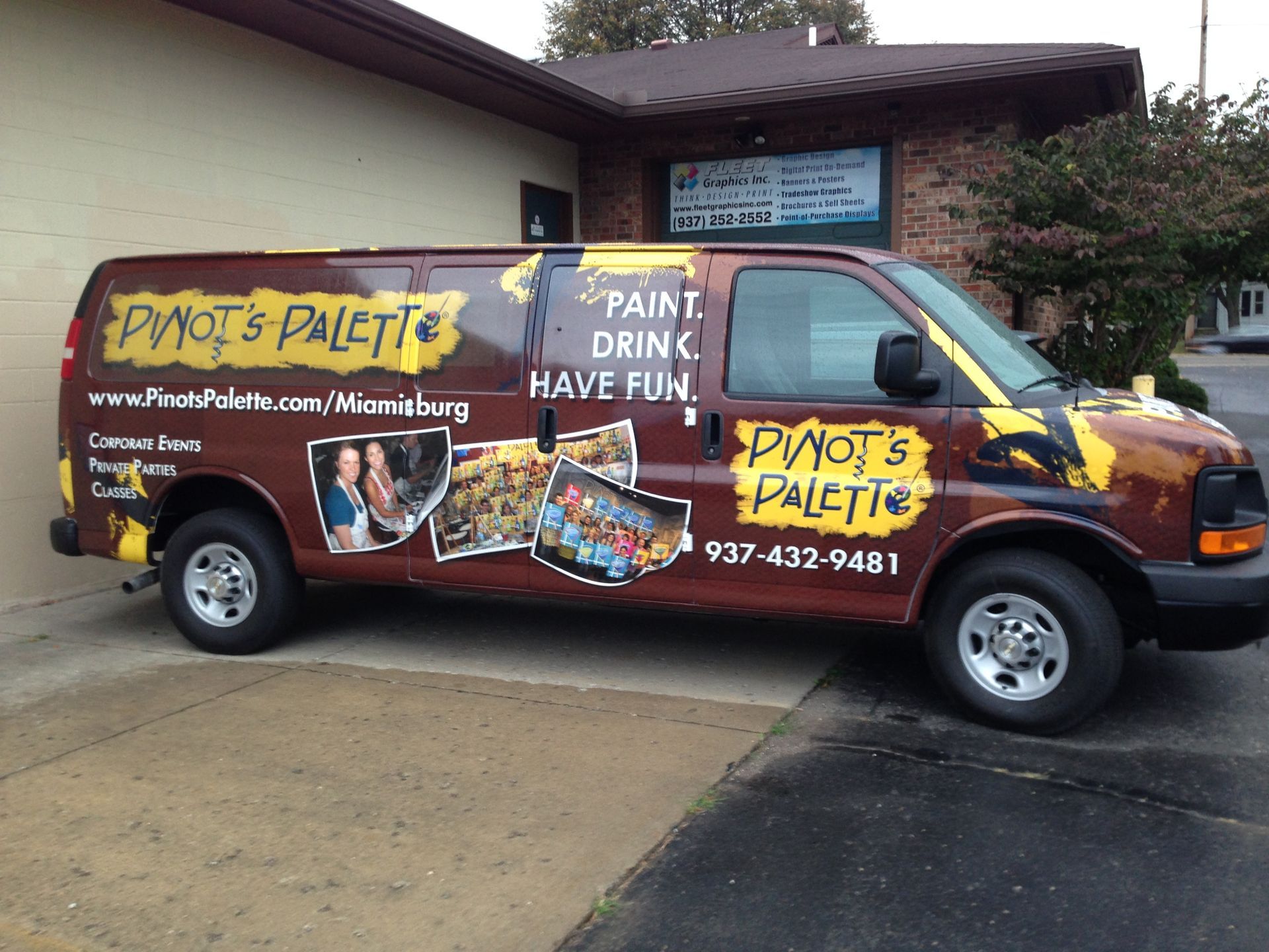 Van for PVOT's Palette art studio, brown with yellow accents, parked in front of a building in Williamsburg.