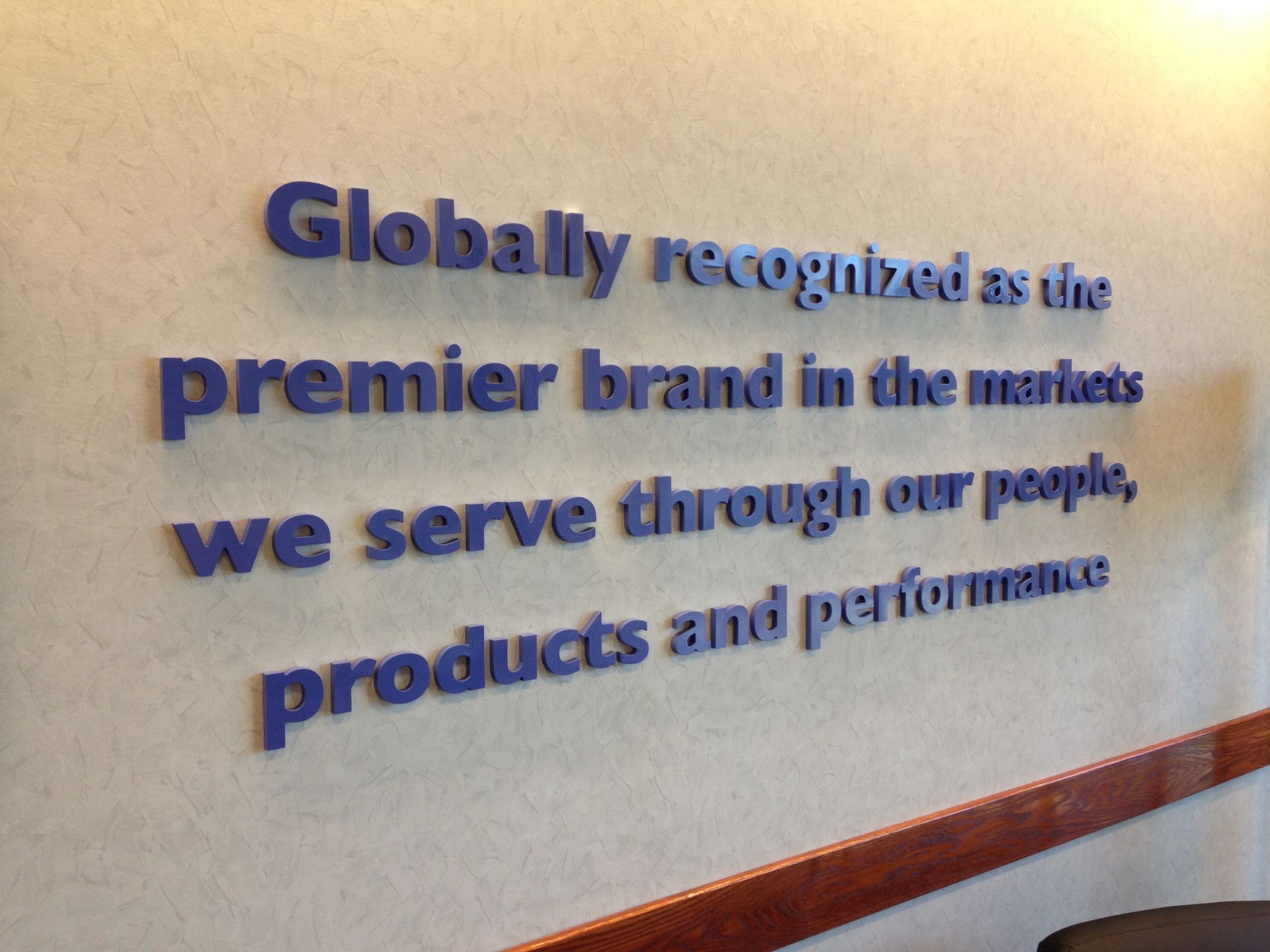 Blue text on a beige wall: 