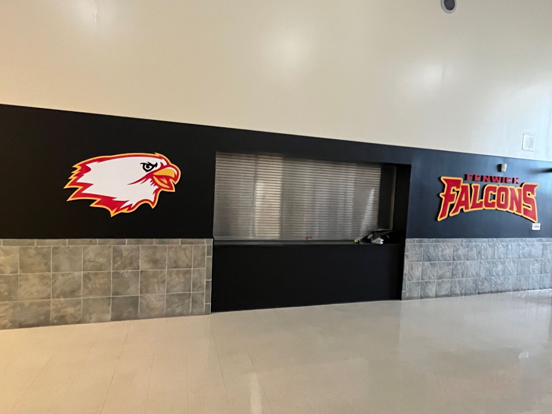 Black wall with Falcon logo and 