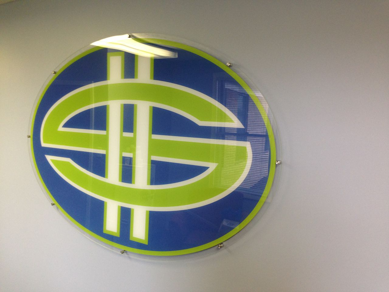 Blue and green circular logo with a stylized 