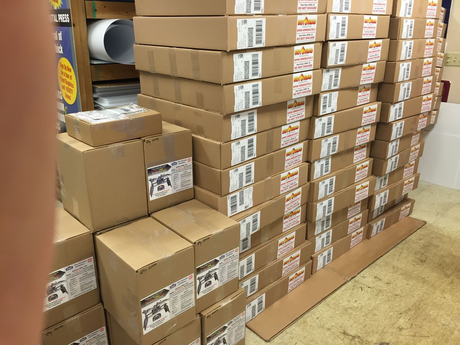 Stack of cardboard boxes in a warehouse. Some have shipping labels.