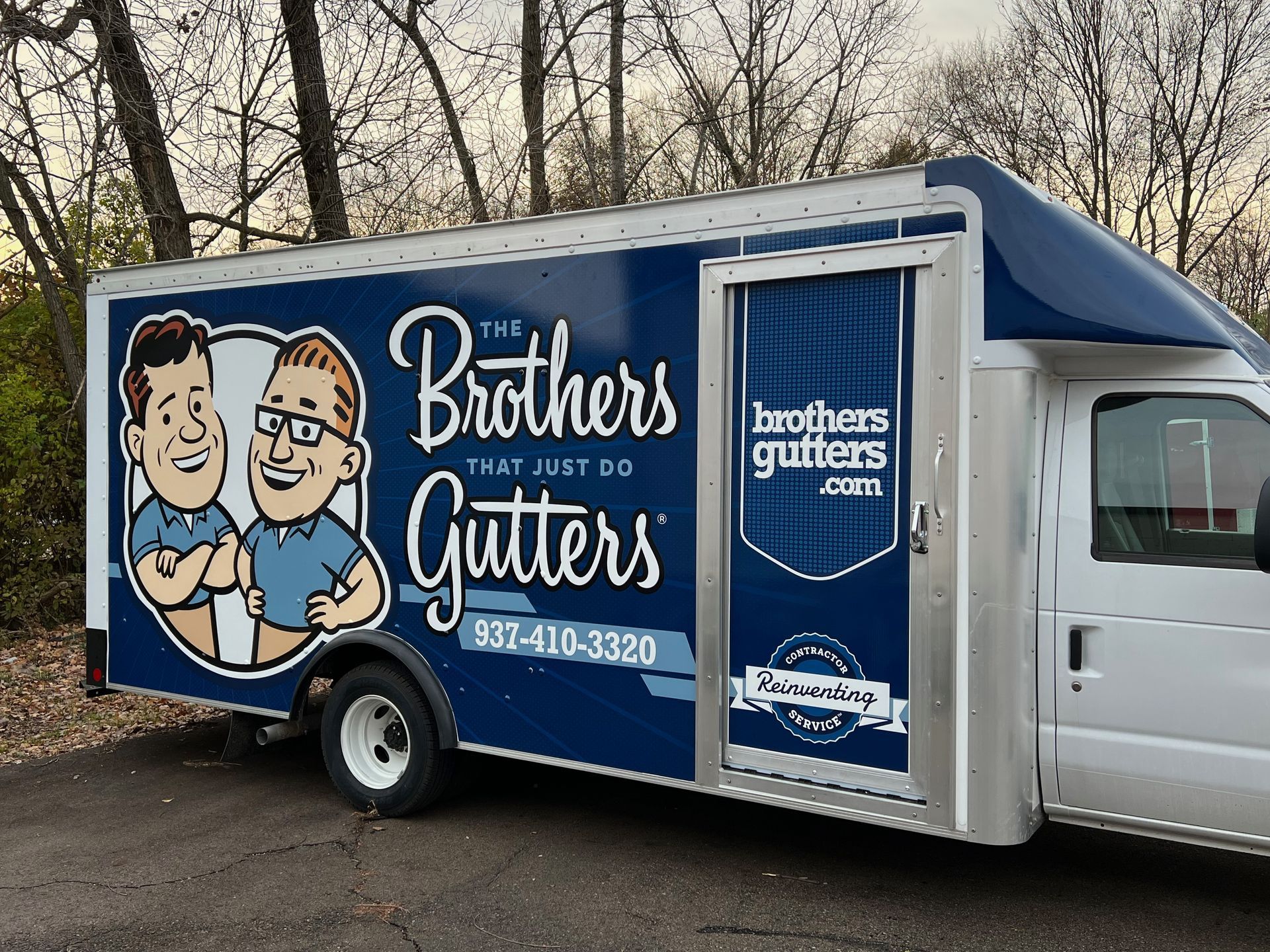 Blue Brothers Gutters service truck with cartoon logo.