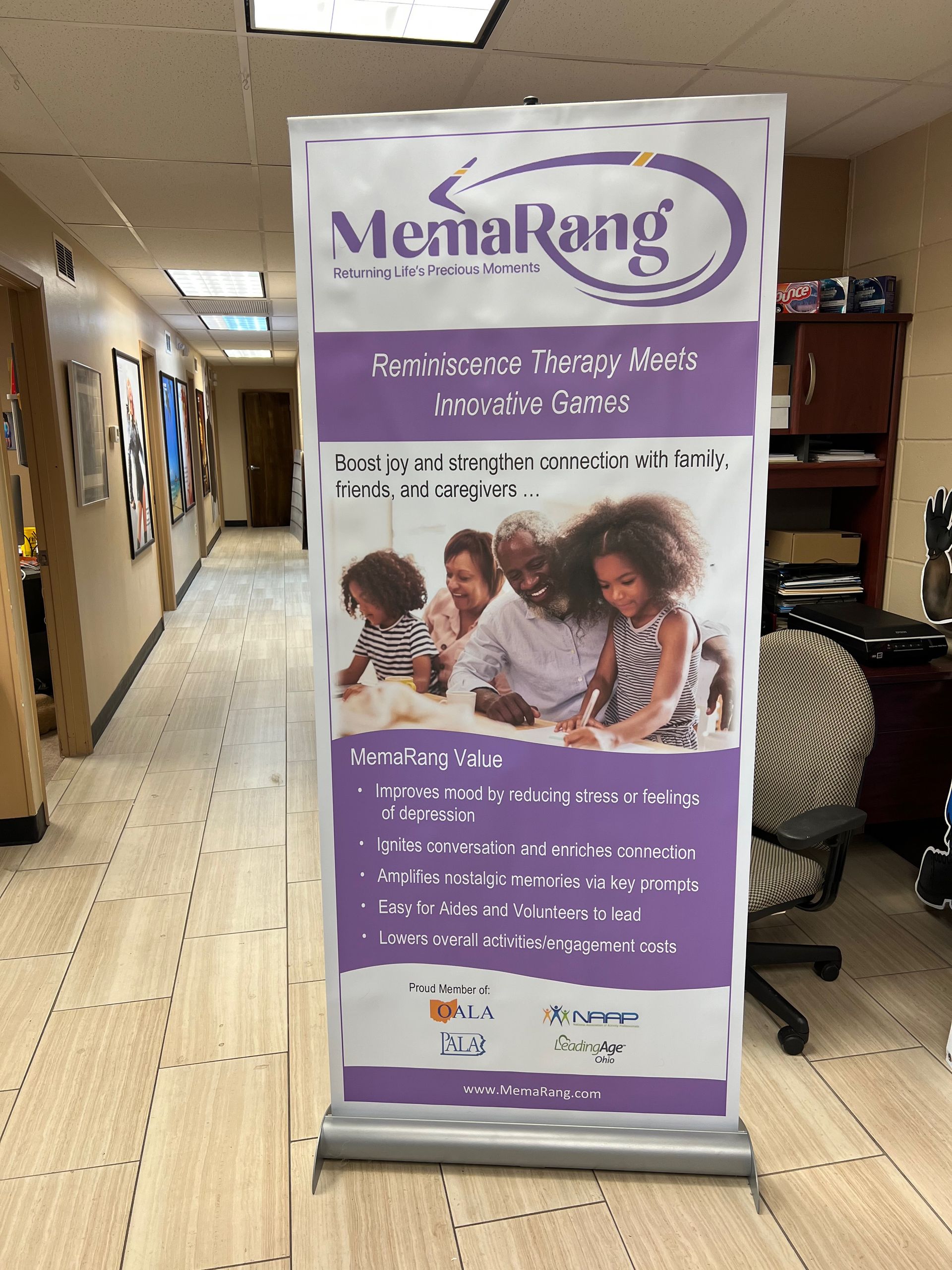 Banner ad in office hallway; purple and white colors, promoting 