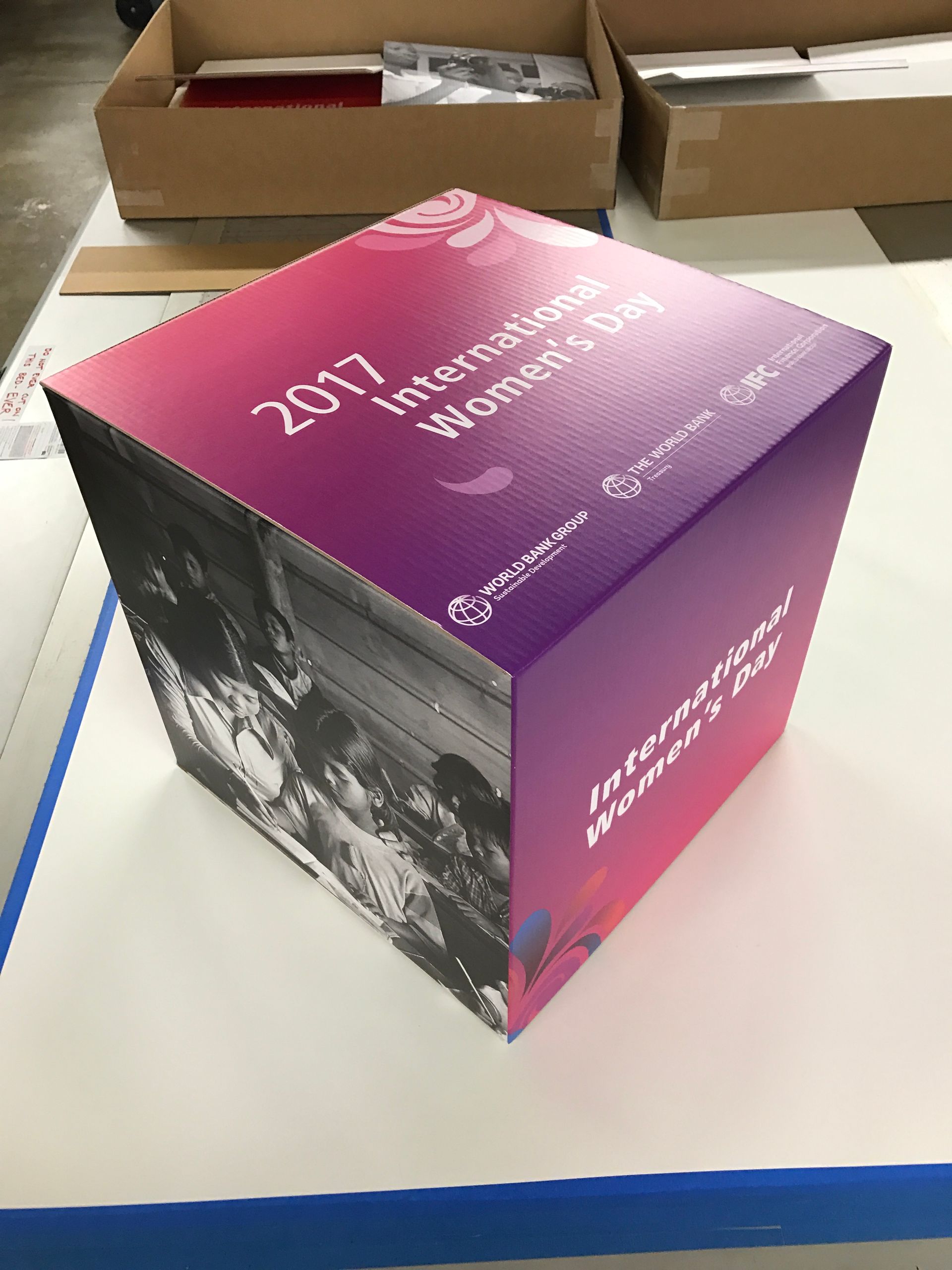 Cube for 2017 International Women's Day with a gradient pink/purple top, photos, and text.