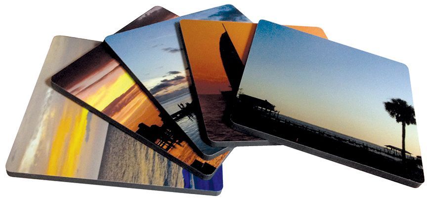 Stacked square coasters with sunset photographs.