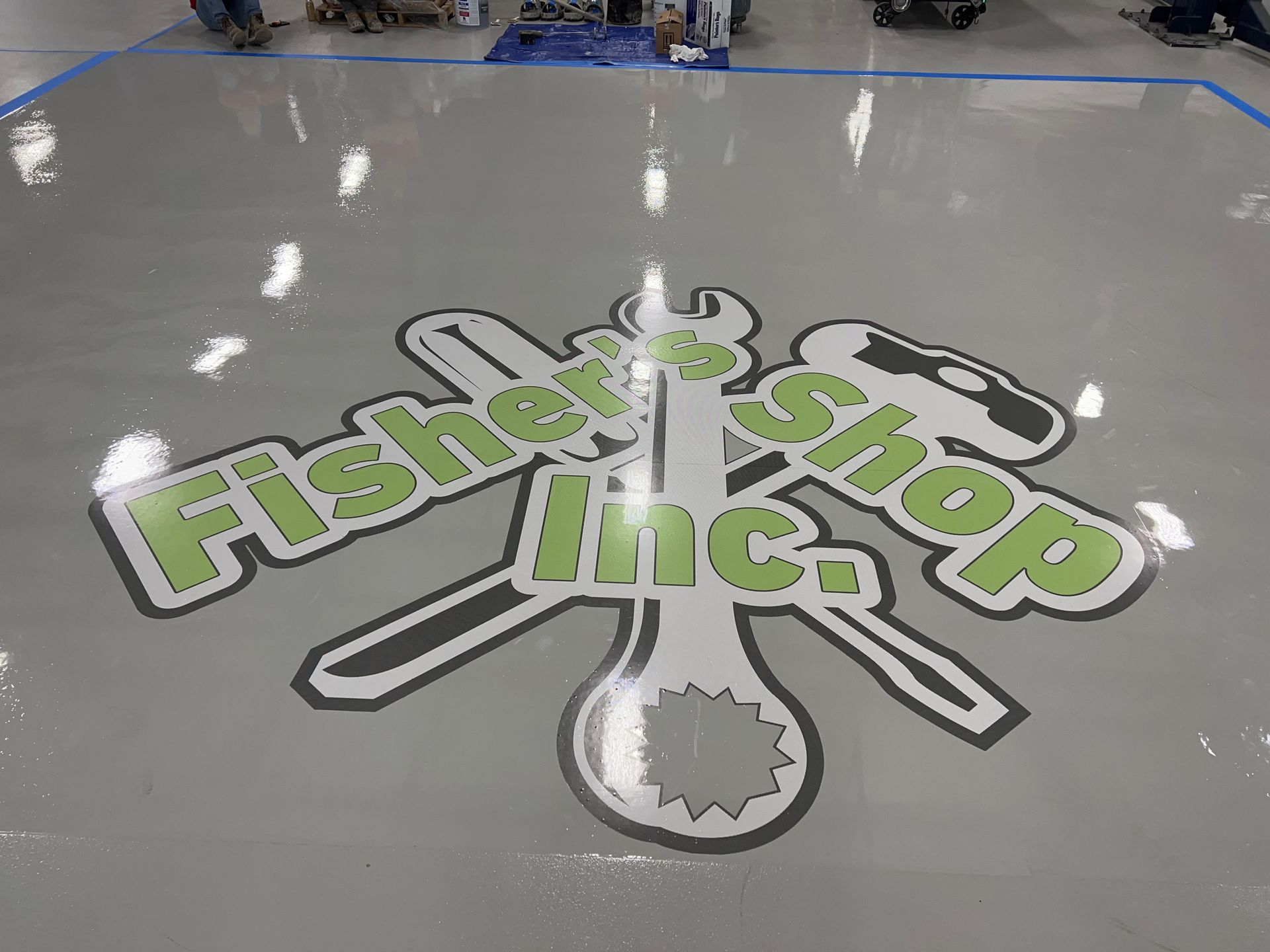 Floor of a shop with a company logo,